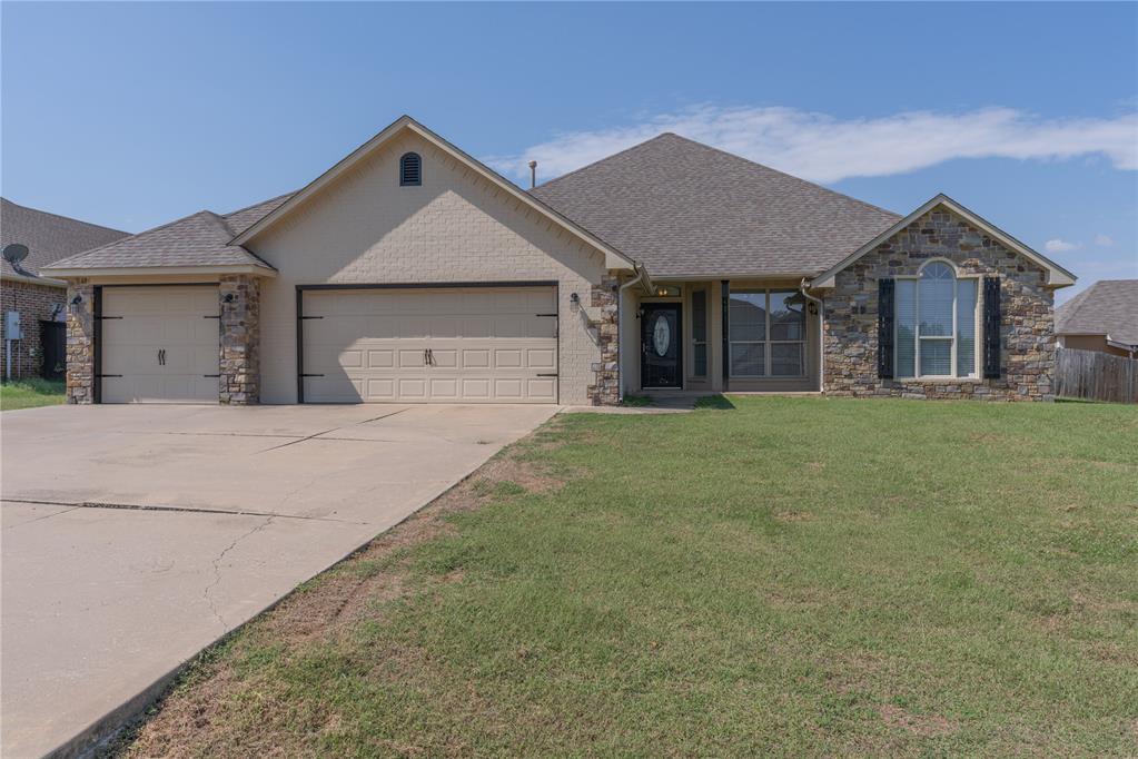 Welcome to this beautifully maintained 3-bedroom, 2-bathroom home with an office and a 3-car garage, perfectly situated in Norman. The open-concept layout is enhanced by wood flooring that flows throughout the main living areas. A formal dining area right off the entryway adds a touch of elegance, leading into the living room where a beautiful wood-trimmed fireplace and large windows create a warm and inviting atmosphere with abundant natural light. The kitchen offers ample storage, a breakfast bar for extra seating, and a charming bay window in the dining area. The primary bedroom is a true retreat with a tray ceiling, dual vanities, a large corner jetted tub, and a separate walk-in shower. Outside, a covered patio off the kitchen and a spacious backyard provide plenty of room for a garden or to add a pool, complete with a small storage shed for your tools. This home offers the perfect combination of style, comfort, and space for all your needs.