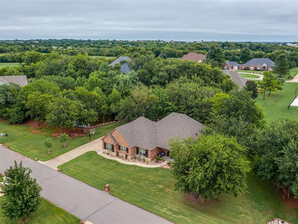Welcome to Olde Stonebridge, where comfort and style come together in this stunning custom home. Tucked on a spacious lot with a tree-lined pond just beyond your backyard, this property offers a rare mix of privacy and tranquility. Inside, the open layout flows seamlessly from the living and game room into a chef-inspired kitchen with a granite island, custom cabinetry, and plenty of room for entertaining or quiet nights at home.

The library is a true showstopper, with wall-to-wall built-ins creating the perfect space for a home office, reading lounge, or stylish hangout. The front bedroom features a convenient Murphy bed, while upstairs, a mini split HVAC system makes the finished bonus room ideal for a game room, media room, or whatever fits your lifestyle. The primary suite feels like a retreat of its own, with refined tray ceilings, a resort-style bathroom designed for relaxation, and a boutique-inspired closet with custom shelving and drawers for effortless organization.

This home is packed with thoughtful extras, including slide-out shelving in the kitchen, a full sprinkler system, an above-ground storm shelter for peace of mind, and a generator to keep you powered through any outage. Recently updated with a $10,000 price improvement and offered by a motivated seller, this property is a rare opportunity. Whether you’re sipping coffee on the patio with peaceful pond views, hosting friends in the game room, or soaking up the serene setting, this home blends luxury and everyday living perfectly. Schedule your private showing today and see why Olde Stonebridge is one of the most desirable communities in the area.