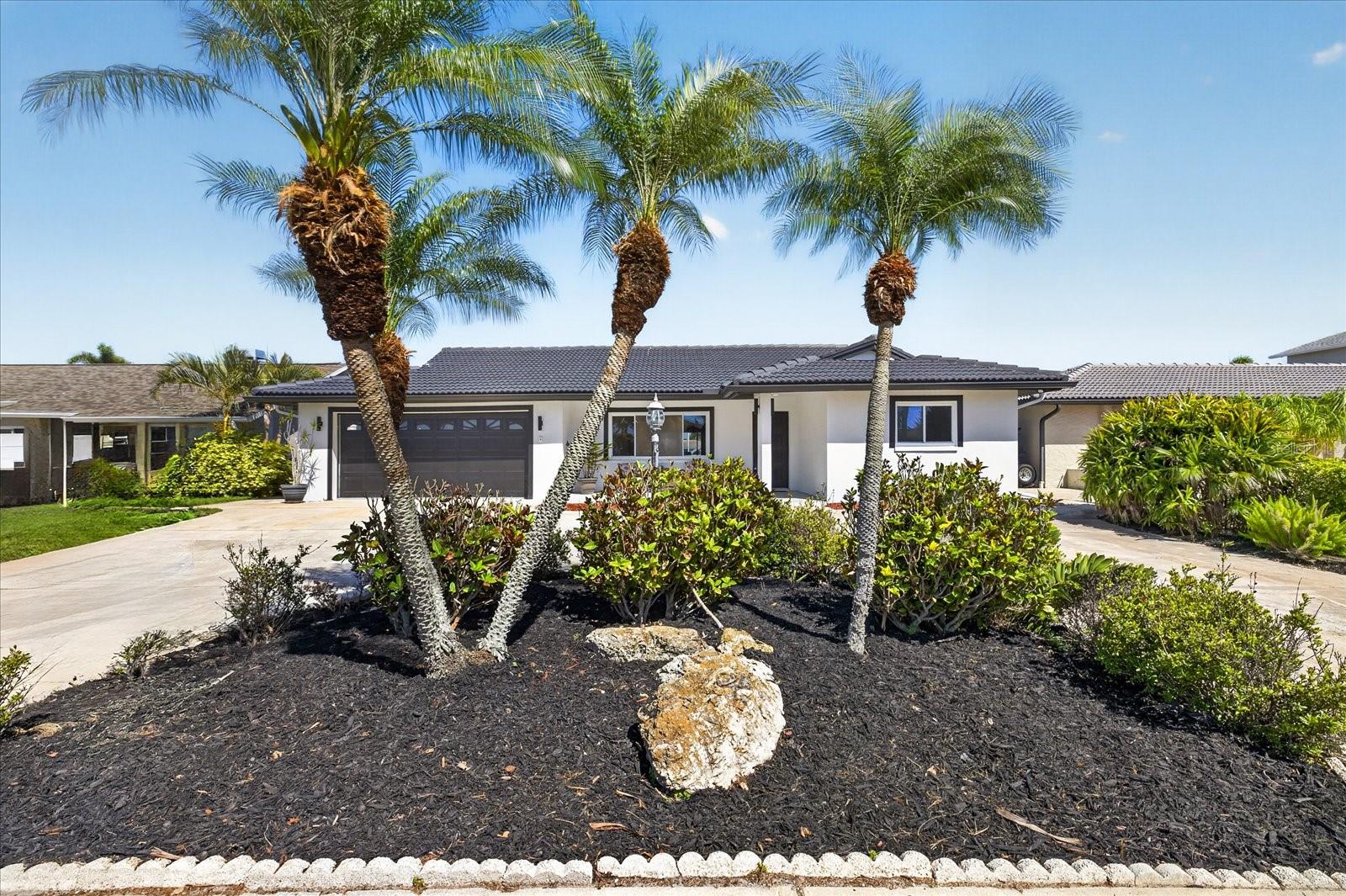 Beautifully updated 3 bedroom, 2 bath, 2 car garage,  1712 sq.ft. waterfront home in true move-in condition! Situated on a wide, deep water canal with highly desirable eastern exposure, this home offers peaceful sunrises and cooler afternoons with stunning water views. The screened-in pool creates the perfect setting for relaxing or entertaining while enjoying the serene waterfront backdrop.A large yard provides ample space for outdoor living, pets, or future customization, while the circular driveway offers essential extra parking for guests and gatherings. The garage has been finished with durable and attractive epoxy flooring, adding both function and style.Inside, you’ll find a light & bright open split-bedroom floor plan designed for comfort and privacy, along with beautiful water views from multiple areas of the home. The spacious all-new kitchen features stainless steel appliances, custom cabinetry and solid surface countertops offering ample storage and beautiful pool and water views from the large farm sink. Updates include new tile roof in 2006, new electrical panel; plumbing updates and more in 2025.   Located just around the corner from the open Gulf, this property is a boater’s dream.Gulf Harbors community residents enjoy a golf cart-friendly neighborhood, optional private beach access, and close proximity to downtown New Port Richey’s shops, dining, and events. This well-maintained neighborhood offers a strong sense of community and the perfect setting to enjoy the Florida waterfront lifestyle year-round.Located in the sought-after Gulf Harbors community, with optional access to the exclusive Gulf Harbor Beach Club, this property offers a rare opportunity to own a well-built waterfront home with true direct Gulf access. Community is golf cart friendly ; historical Downtown New Port Richey is less than 4 miles away where you will find many restaurants and shops and Sim's Park which is an outdoor community venue that host various outdoor events such as festivals and concerts throughout the year. Come see this gorgeous waterfront home today and start living the Florida waterfront lifestyle today!