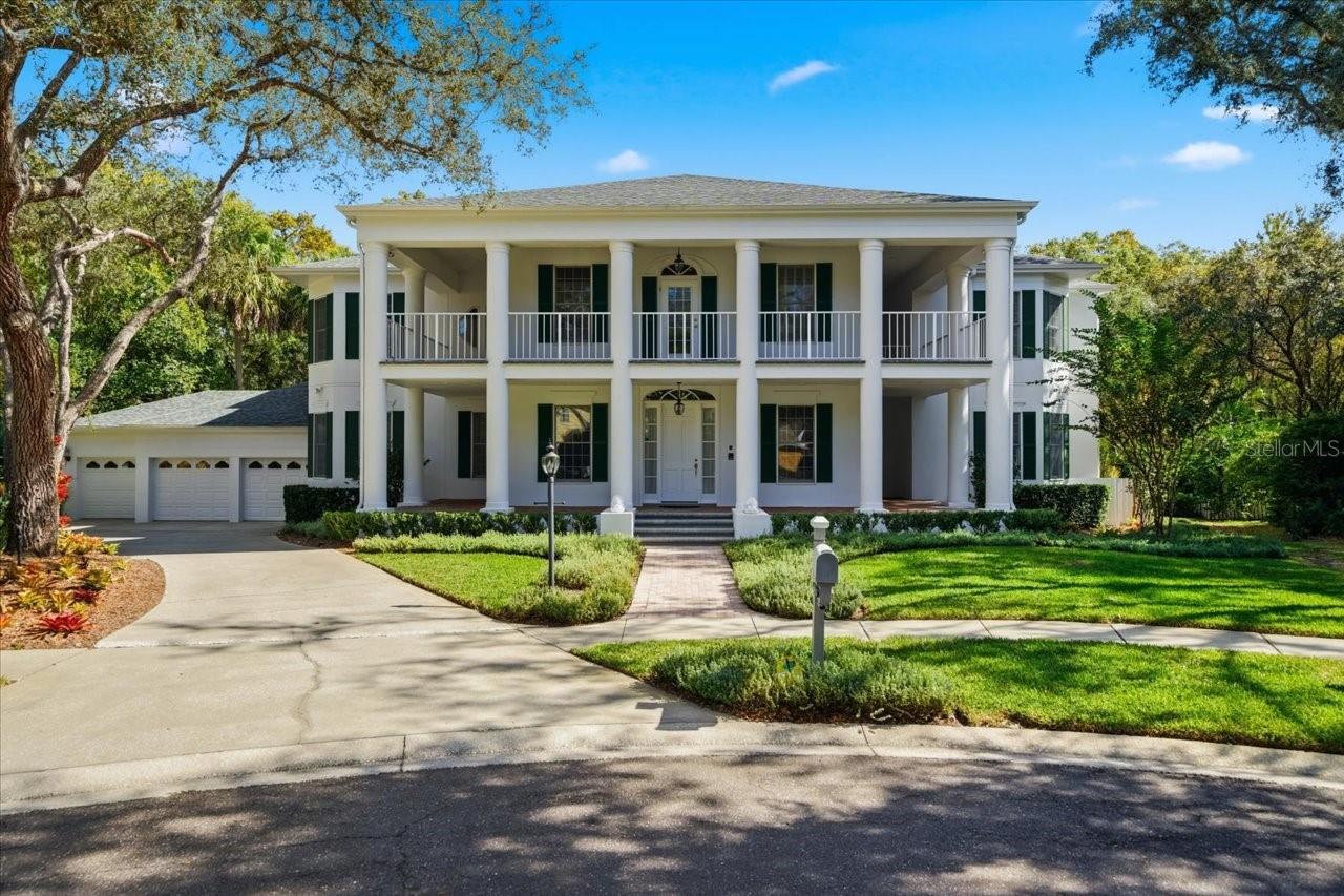 One or more photo(s) has been virtually staged. Stately Antebellum-Inspired Estate in Tampa PalmsNestled on a peaceful cul-de-sac in the beautiful Tampa Palms community, this stunning 4-bedroom, 5.5-bath residence with office, in-law apartment, and 3-car garage blends Southern charm with modern luxury. From its stately columned façade to its sweeping conservation views, every detail of this home reflects elegance and thoughtful design. Inside, the spacious floor plan offers both grand entertaining spaces and intimate retreats. The elegant kitchen features a large center island, abundant cabinetry, walk-in pantry, and a butler’s pantry—perfect for hosting gatherings. The adjoining family room and dinette area open to the outdoor living space, where a sparkling pool in the screened lanai and a spa in the backyard overlook serene, wooded views. The luxurious primary suite is a true sanctuary, complete with a private sitting area, spa-style bath with dual vanities, walk-in shower, and garden tub. A massive built-in closet system and additional walk-in closet provide exceptional storage. Each secondary bedroom offers en-suite access and generous closet space, while the in-law apartment (one of the four bedrooms) includes its own entrance, living area and 2 full baths for added comfort and privacy. The executive office offers built in shelving and hidden room behind one of the bookcases.  The home offers abundant storage throughout, and a beautifully landscaped setting.