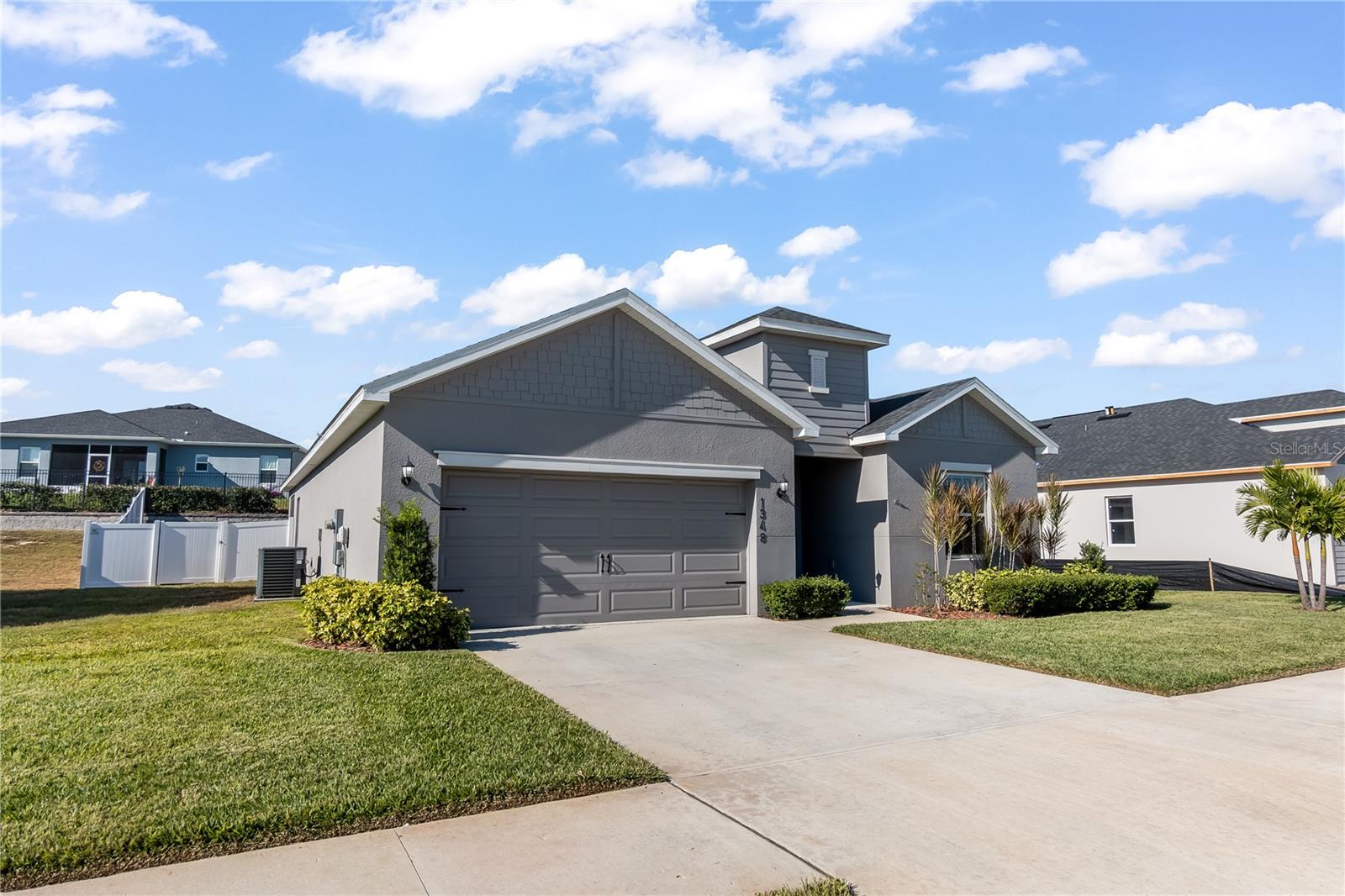 Built in 2023, this "Shelby" floor plan offers 2,056 sq. ft. of pristine, modern living with the peace of mind only a nearly-new home provides. Featuring 4 spacious bedrooms and 2.5 baths, the heart of this home is a chef-inspired kitchen with stone-gray shaker cabinets, quartz countertops, and a massive social island perfect for hosting. The primary suite is a true retreat, boasting tray ceilings and a spa-like en-suite. Enjoy sunset views from your screened-in lanai or let the kids and pets roam in the newly vinyl-fenced backyard. With NO CDD fees and an ultra-low HOA, this is the most affordable way to live the "Chain of Lakes" lifestyle.