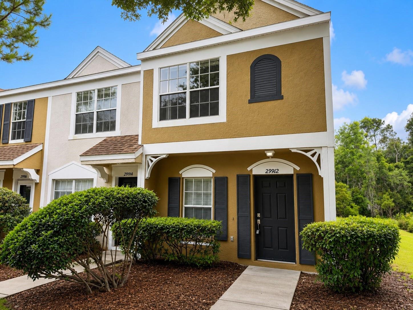 Virtually Staged. Welcome to this beautifully maintained corner-unit townhome in the gated community of Covina Key at Meadow Pointe II in the heart of Wesley Chapel. Offering peaceful pond views and added privacy, this move-in-ready home features a bright, open-concept floor plan with spacious living and dining areas that flow seamlessly into the kitchen, making it ideal for both everyday living and entertaining.The home features tile and laminate flooring throughout, providing a modern look with easy maintenance. Upstairs, you’ll find generously sized bedrooms, including a spacious primary suite with a private bath and ample closet space. Relax on the covered lanai while enjoying tranquil pond views from this premium corner location. Residents enjoy a maintenance-free lifestyle with access to Covina Key’s private pool, as well as Meadow Pointe II’s exceptional amenities, including a clubhouse, fitness center, resort-style pool, tennis and basketball courts, playgrounds, and walking trails. Ideally located just minutes from Wiregrass Mall, Tampa Premium Outlets, AdventHealth, BayCare Hospital, top-rated schools, restaurants, entertainment, and convenient access to I-75 and I-275, this home offers the perfect combination of comfort, convenience, and location.