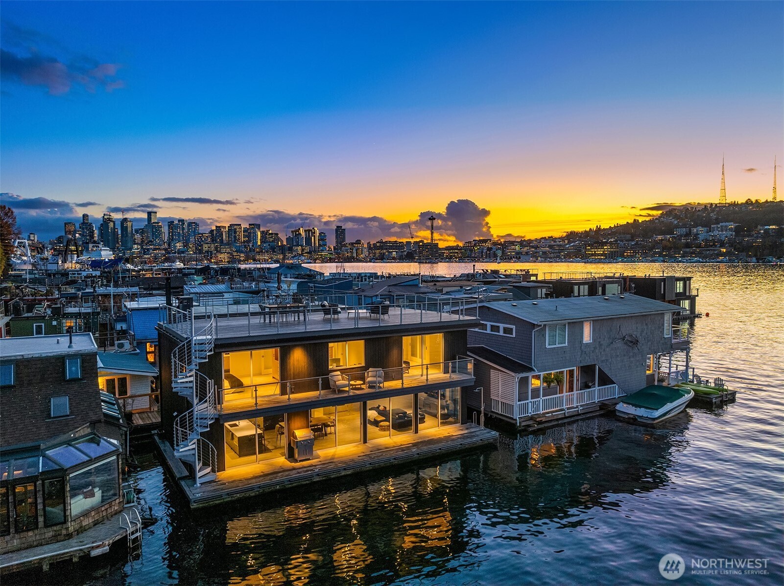Seattle’s only Built Green certified floating residence. This home touts elevated architectural intention, nestled on an undevelopable channel in the heart of Eastlake. Clad in sustainable Shou Sugi Ban, this 2 bed, 3 bath private sanctuary features expansive deck off the living room with outdoor shower, luxe security & sound systems, single car garage, & refined living. No detail missed. Saunter up the spiral staircase to expansive rooftop terrace & soak in the sunrise, sunset & city lights - or iconic Seattle fireworks! Built with integrity & curated for those seeking an organic connection to water, light, & sustainable luxury. A unique lake lifestyle that is worthy of your next chapter. Inquire about potential for a fully furnished sale.