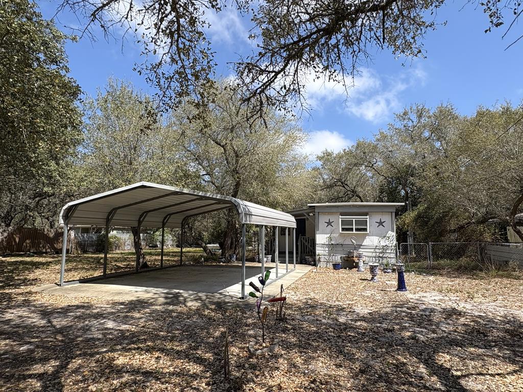 Affordable opportunity to get into the Rockport coastal lifestyle! This 2-bedroom, 1-bath mobile home offers a great starting point for buyers seeking a weekend getaway, investment, or full-time residence with room to add value through some sweat equity. Situated outside city limits (RV allowed), enjoy fewer restrictions with ample space for your boat, RV, and outdoor gear&mdash;perfect for fishing enthusiasts and coastal living. The oversized lot features mature trees for natural shade, a fenced backyard, and a spacious front covered carport for convenient parking. Inside, the home is livable with an open living area and functional layout ready for your personal updates and TLC. A small covered entry porch adds charm and a welcoming touch. Located just minutes from Aransas Bay, Cove Harbor Marina, and Estes Flats, this property offers flexibility, value, and the opportunity to create your own coastal escape.