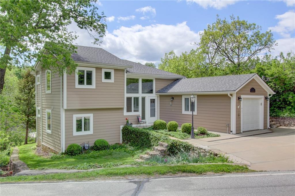 Welcome to this beautifully remodeled and expanded first-tier Lake Lotawana home, offering a rare blend of charm, character, and lakefront convenience. With 5 bedrooms, 3 full baths, and stunning lake views, this home is ready for memory-making.

The open main level features vaulted ceilings, hardwood floors, and hand-harvested logs from the Lake Lotawana lakebed, adding a rich layer of warmth and history to the living space. A wall of windows frames serene cove views and floods the home with natural light.

Step outside to enjoy your covered boat-well dock, swim dock, and covered shore station—just steps from your back door. The property also includes three second-tier lots, perfect for future expansion, parking, or guest space.

Don’t miss this rare opportunity to own a move-in-ready lake home with unique character and incredible extras—Lake Life is calling!