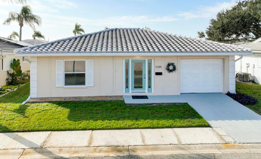 This light and bright 2 bedroom, 2 bath home has been beautifully remodeled with new porcelain tile 
throughout, new kitchen cabinets, stainless appliances, fixtures and bathrooms. When entering, you are welcomed with a spacious living room. Past the dining area, through the french doors you enter the cozy Florida room overlooking a cute patio where you can enjoy sipping your morning coffee or a quiet evening with friends. Down a private hallway, past the large closets is a sizable primary suite with a private en-suite bathroom and access to the Florida room. Bring your clothes, this home is turnkey, absolutely move-ready. 
 The community amenities include a clubhouse, heated pool, library, auditorium, game room w/pool tables & bingo, shuffleboard & workout room with updated equipment and the HOA fee includes cable, internet, building exterior and lawn mowing, water, sewer and trash pick-up. Conveniently located near shopping, restaurants, entertainment and recreations and just a short drive to I-275, airports, St Petersburg, Tampa, and beautiful gulf beaches.