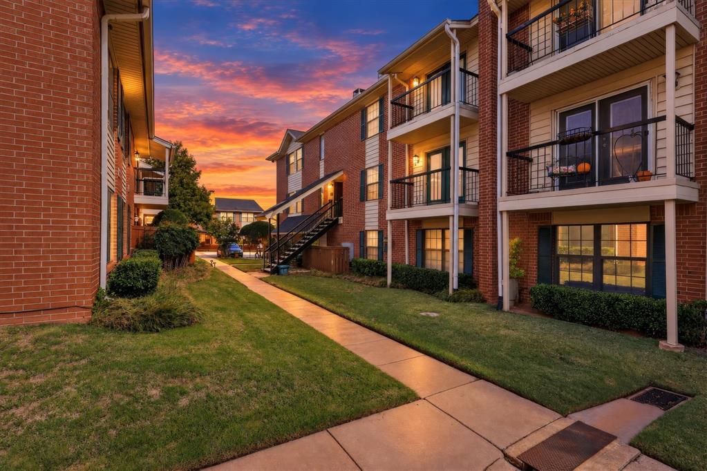Discover spacious, low-maintenance living in the gated Hemingway condominium community! This two-bedroom, two-and-a-half-bath condo offers approximately 1,614 square feet of living space with a functional two-story layout designed for comfort and entertaining. The inviting living area features a painted brick fireplace, while the kitchen offers generous counter space, ample cabinetry, and a large pantry. A separate laundry room and wet bar add everyday convenience. Both full bathrooms feature attractive wood-look tile flooring and subway tile showers. Two private outdoor spaces provide additional room to relax or unwind. Residents enjoy access to the community swimming pool, gated entry, and covered parking. Conveniently located near Penn Square Mall, Classen Curve, the Paseo Arts District, shopping, fine dining, and entertainment. Enjoy the benefits of condominium living.