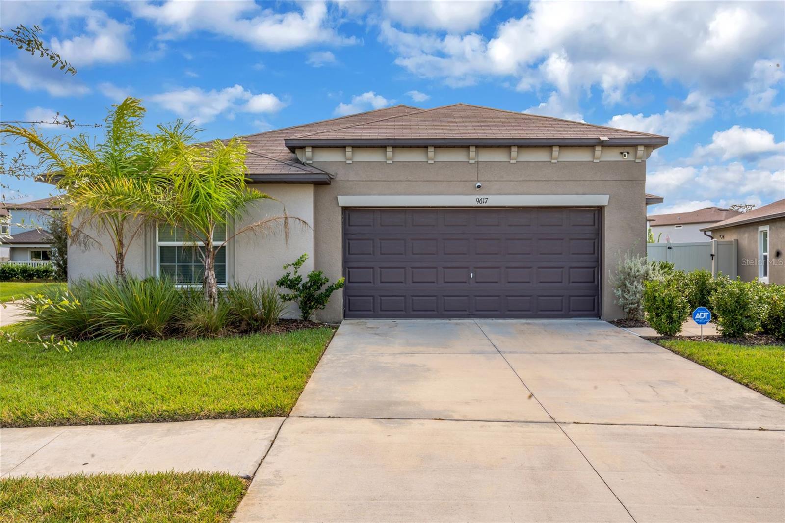 Welcome to the resort lifestyle of EPPERSON LAGOON in Wesley Chapel! This beautifully customized 2022 home offers 4 bedrooms, 2 bathrooms, 1,810 square feet of thoughtfully designed living space, and a 2 car garage with a spacious backyard enclosed by a full vinyl privacy fence.From the moment you enter, the attention to detail sets this home apart. Luxury vinyl plank flooring flows throughout the living areas, complemented by striking custom accent walls, modern lighting, and an open floor plan designed for both everyday comfort and entertaining.The impressive kitchen features white shaker cabinetry, gorgeous quartz countertops with dramatic veining, stainless steel appliances, a stylish tile backsplash, a generous island with seating, and a walk in pantry. The adjoining dining and living areas create a welcoming space, highlighted by a distinctive teal and metallic accent wall and a sleek built in electric fireplace.The split bedroom floor plan provides privacy, with the primary suite offering a beautifully appointed bathroom featuring dual sinks, illuminated vanity mirrors, a frameless glass shower with elegant porcelain tile, and a spacious walk in closet. Custom built in closet systems throughout the home provide exceptional storage and organization. Three additional bedrooms offer flexibility for guests, a home office, or additional living needs. An interior laundry room adds everyday convenience.Step outside to an extended concrete patio, perfect for outdoor dining, entertaining, or relaxing. The spacious backyard is fully enclosed with a vinyl privacy fence and offers plenty of room to create your own private pool oasis with a screened enclosure, subject to applicable approvals.And then there's EPPERSON! Experience the incredible approximately 7.5 acre crystal clear lagoon with sandy beaches, swimming, kayaking, waterslides, and recreational activities. The community also features playgrounds, a dog park, scenic walking and biking trails, and beautiful green spaces. Conveniently located near I-75, shopping, dining, and everything Wesley Chapel has to offer.Enjoy a home filled with character, thoughtful upgrades, and access to one of Tampa Bay's most distinctive resort style communities!