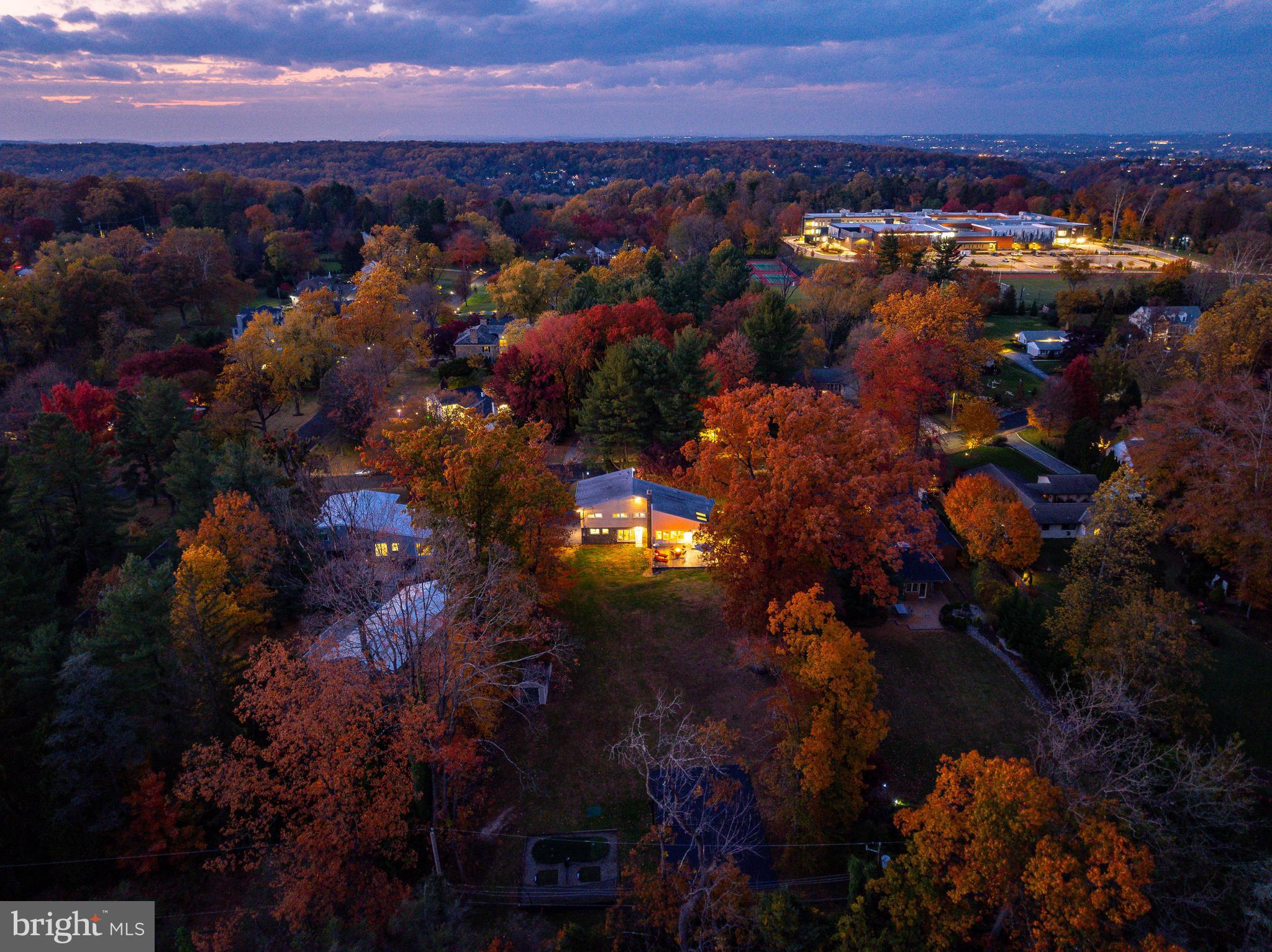 Sunday Open House CANCELED. Nestled in a bucolic setting in exclusive, sought-after Northside Villanova, 407 Clairemont Road combines architectural character, modern comfort, and move-in-ready appeal. This elegant four-bedroom, two-full and two-half-bath split-level residence offers 2,630 square feet of living space on a flat, private ¾-acre lot in Lower Merion Township, complete with a two-car attached garage. Perfectly positioned within a quiet community of cul-de-sacs, mature trees, and friendly neighbors, this home provides a rare combination of tranquility, functionality, and accessibility.A dramatic two-story foyer with expansive windows welcomes you inside, where warm hardwood floors flow throughout. The home’s design emphasizes space, light, and balance, creating a natural sense of openness that carries through every level.The vaulted great room with 16-foot ceilings is the heart of the home, anchored by a striking stone wood-burning fireplace and newly refinished hardwood floors. Natural light pours through oversized windows, while the excellent flow between rooms makes entertaining effortless. The open-concept layout seamlessly connects the living, dining, and kitchen areas—perfect for gatherings, celebrations, and easy indoor-outdoor living.The beautifully updated kitchen blends timeless design with modern function, offering solid cherry-wood cabinetry, pull-out pantry drawers, granite countertops, and stainless-steel appliances—including a six-burner vented cooktop, KitchenAid double ovens, and a professional-grade refrigerator/freezer. A sun-filled breakfast area, illuminated by dual skylights, opens through sliding doors to the new patio, ideal for morning coffee or al-fresco dining.A powder room and coat closet complete the main level, enhancing day-to-day functionality.Upstairs, you’ll find four bedrooms, including one that works beautifully as a home office or guest suite. Three bedrooms feature original hardwood floors and ample natural light, while the primary suite offers plush carpeting, a spacious walk-in closet, and an updated en-suite bath with a granite-topped vanity, glass-enclosed shower, and custom cabinetry. The hall bathroom features a jetted tub/shower combination, providing both comfort and convenience for family or guests.Lower-Level Living: The walk-out lower level provides additional versatility with a large recreation or family room, full-size windows, and direct access to the backyard. A half bath, laundry area, and interior garage access complete this level.The property’s ¾-acre, fully fenced backyard is a rare find—flat, private, and directly adjacent to Natural Lands’ Stoneleigh, a renowned natural garden, and Oakwell, an arboretum estate. This unique backdrop ensures permanent privacy and protected views, with no possibility of future development. The yard features a half-court basketball area, pickleball court, and two-station golf driving net and putting green, along with a 10×20 shed—offering endless possibilities for recreation, play, and relaxation.Thoughtfully enhanced with refinished hardwood floors, freshly painted interiors, newer front, rear, and lower-level windows, HVAC (2020), hot-water heater (2023), new patio, new front walk, and driveway sealcoating (2025), plus a new patio slider and entry glass (2025), and ceiling fans in three of four bedrooms. A Lutron Smart Hub system provides smart-home convenience, controlling exterior lighting as well as lighting in the kitchen and primary bedroom.Located within the Black Rock Middle School neighborhood and 0.6 miles to the school, this peaceful enclave is known for its cul-de-sacs, minimal traffic, and walkable community feel. The Lower Merion School District bus stop sits just one house away. Ideally situated minutes from Villanova University and train station, King of Prussia, and under 25 minutes to Center City Philadelphia, this location offers the perfect balance of privacy and accessibility.