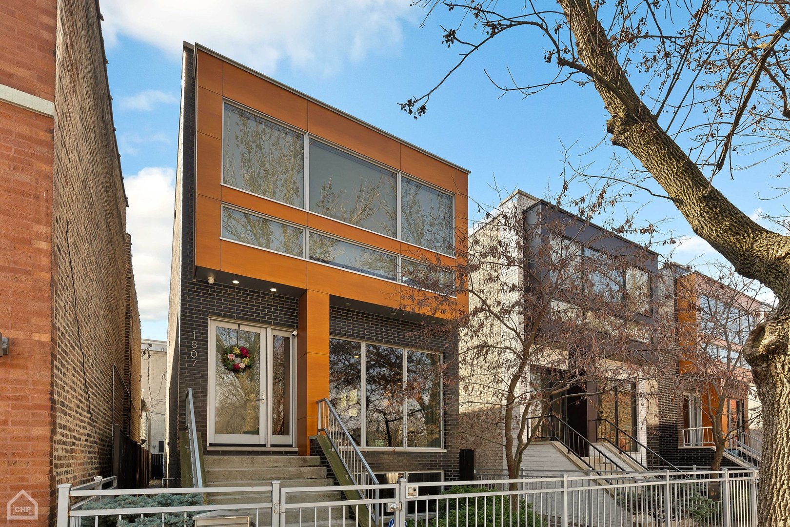 Welcome to contemporary luxury living in sought after West Town! Meticulously maintained, this stunning 4-bedroom, 3.5-bath single-family home, is a showpiece of modern design and elegance, boasting exceptional craftsmanship and high-end finishes throughout. As you enter, you are greeted by a spacious and bright formal living and dining room, featuring a gas fireplace and custom ceiling treatment over the dining area. The gourmet kitchen is adorned with white quartz countertops, a large island with a breakfast bar, custom tile backsplash, and high-end stainless steel appliances including a double oven, 5 burner gas cooktop, dual dishwasher drawers, built-in espresso maker, and wine fridge. The kitchen flows seamlessly into a family room with another gas fireplace, opening up to a garage rooftop deck perfect for grilling and entertaining. The luxurious main suite features separate vanities, a glass-enclosed steam shower, heated floors, a jacuzzi tub, and a custom walk-in closet. Two additional bedrooms are thoughtfully positioned for privacy and share a beautifully appointed full bath with modern fixtures. The lower level offers a large family room with a marble wet bar, laundry room and a spacious guest suite/4th bedroom with a full bath. Two-car garage. Situated in a prime location with a 15 minute walk to Wicker Park or West Loop, this home provides easy access to shops, restaurants, parks and entertainment.