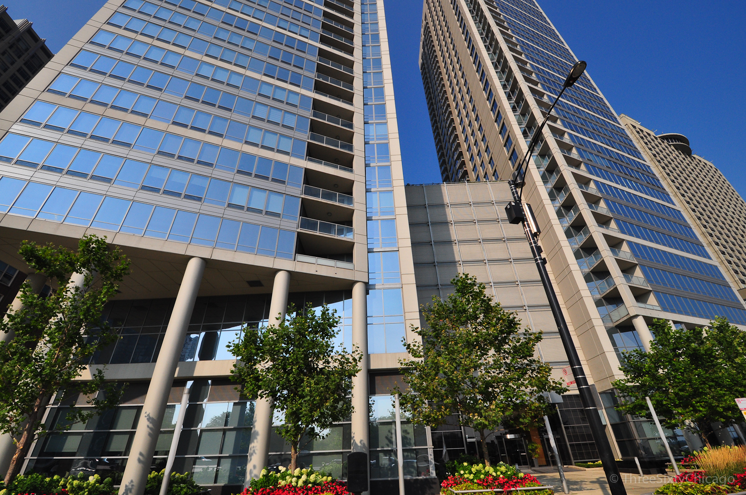 Price improvement on the highest floor largest 3 bedroom making 3105 the best value in the building with new paint throughout, refinished hardwood floors, and parking included! This remarkable high-floor residence boasts northeast water views and is the largest three-bedroom unit in the North Tower at 600 Lake Shore. Upon entering the impressive foyer, one is greeted by an elegant tray ceiling, marble flooring, and custom lighting, which immediately showcases breathtaking views of the lake, Ohio Street Beach, Olive Park, and Navy Pier from every window. The gourmet kitchen seamlessly connects to the living and dining areas, featuring rich wood cabinetry, undermount lighting, granite countertops with a custom backsplash, modern stainless-steel appliances, tiled floors, and a double oven. The expansive breakfast bar comfortably accommodates five full-sized seats and is enhanced by custom overhead lighting. The open layout of the living, dining, and kitchen areas facilitates effortless entertaining, with access to a spacious inset balcony ideal for savoring morning coffee or cocktails against the stunning backdrop of Lake Michigan. Designer elements include custom window treatments, crown molding throughout, and silent Somfy motorized shades that cover the wall of windows in the living room, revealing sweeping lake views. The refinished Brazilian Cherry wood floors extend into an expanded living area overlooking the lake, which is designed for additional seating and entertainment, complete with a wet bar, custom wine and glass rack, and a beverage refrigerator. The luxurious master suite also offers lake views, custom carpeting, an overhead ceiling light/fan, custom crown molding, and two generously sized custom-built walk-in closets. The ensuite master spa bath features double granite vanities, an oversized custom mirror, a whirlpool tub, and a walk-in shower. The second bedroom includes custom carpeting, northern views, crown molding, a custom ceiling light/fan, and a custom walk-in closet with access to a private balcony. Conveniently located across the hall, the second bathroom showcases marble flooring, custom lighting and mirror, along with a tub/shower combination and sliding glass door. The third bedroom, which offers lake views and hardwood flooring, has been configured as an office but provides ample space for a queen bed and dresser. The suite includes a comprehensive bathroom equipped with a walk-in tiled shower, making it perfect for guests or as a home office. The exquisite powder room, situated conveniently off the foyer, is designed for guests and features a bespoke vanity, a designer mirror, custom lighting, and elegant wall coverings. The laundry room, accessible from the kitchen, is designed to accommodate a full-size side-by-side washer and dryer, along with additional storage space. With exceptional attention to detail in the finishes of this residence, one would genuinely experience an unparalleled lifestyle at the premier address on the lake, 600 LSD!