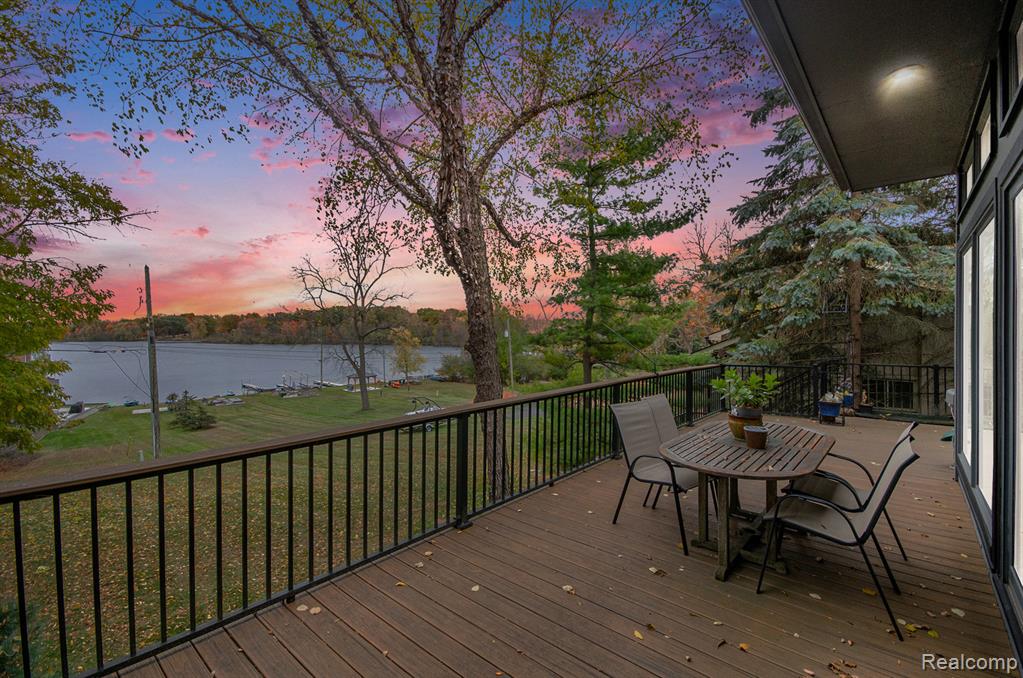 Architecturally inspired by Frank Lloyd Wright Prairie style design, The Doleman House is a Mid Century Modern walkout ranch offering 5 bedrooms, 3.1 baths, and a Cass Lake setting within Herndons Cass Lake Estates. This custom residence emphasizes natural materials, thoughtful design, and a strong connection to its surroundings. The open main level features wide four foot hallways, elevated beam ceilings, expansive windows, and extended interior sightlines that create a light filled living environment with lake and landscape views. A fieldstone fireplace constructed from stones gathered on site anchors the main living area. Rift and quartered white oak flooring with a Swedish finish runs throughout the main level. The kitchen includes Sub Zero refrigeration, under counter freezer drawers, a Wolf five burner cooktop and double oven, Bosch dishwasher, and custom cabinetry integrated into the space. The walkout lower level offers additional finished living space with bamboo flooring, hand cut green tile surrounding the fireplace, pickled white knotty pine ceilings, and direct access to the exterior. Exterior features include a private courtyard with Japanese maples, Trex decking overlooking Cass Lake, and landscaped grounds with a mature Ash tree. An irrigation system sourced from the lake services the landscape. The sale includes the primary residential parcel along with an additional lakefront parcel, providing added separation from neighboring properties and contributing to the overall lakefront setting. Parcel identification number 18 04 379 024 is included. Additional features include a custom birch office or library that may be used as a fifth bedroom, a Japanese art inspired tile bath, newer vinyl windows, an advanced water softening system, and a new roof with new kitchen skylights recently completed.