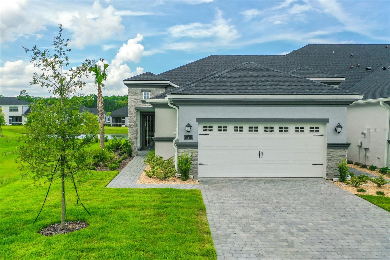 Welcome to this stunning 2-bedroom, 2-bathroom villa with a den/flex room, perfectly situated in one of Ormond Beach's most desirable communities. Overlooking tranquil waters with a soothing fountain, this home combines luxury finishes, thoughtful design, and low-maintenance living.Step inside to find upgraded wood-look tile flooring, plantation shutters, and upscale lighting throughout. The spacious, open-concept kitchen is a chef's dream, featuring 42'' upgraded cabinetry, quartz countertops and backsplash, a large farmhouse-style sink, corner pantry, and an upgraded range—all beautifully designed for both function and style.The primary suite is a peaceful retreat with elegant French doors, two custom walk-in closets, and a spa-inspired ensuite bathroom with a walk-in shower and private water closet. A split-bedroom layout provides privacy for guests, complemented by a well-appointed hall bath.Enjoy the flexibility of a separate den/flex room perfect for a home office, media room, or guest space. The laundry room adds everyday convenience, while the garage impresses with epoxy flooring and extra storage. Loaded with upgrades and move-in ready, this villa offers elegant living in a peaceful, scenic setting close to Ormond Beach's best amenities. Come join the Plantation Bay lifestyle! 45 holes of golf, tennis, pickleball, 2 pools, cabana, spa/fitness center and the New Clubhouse! Buyers of this home will receive a substantial discount onthe initiation fees when you join within 30 days of closing