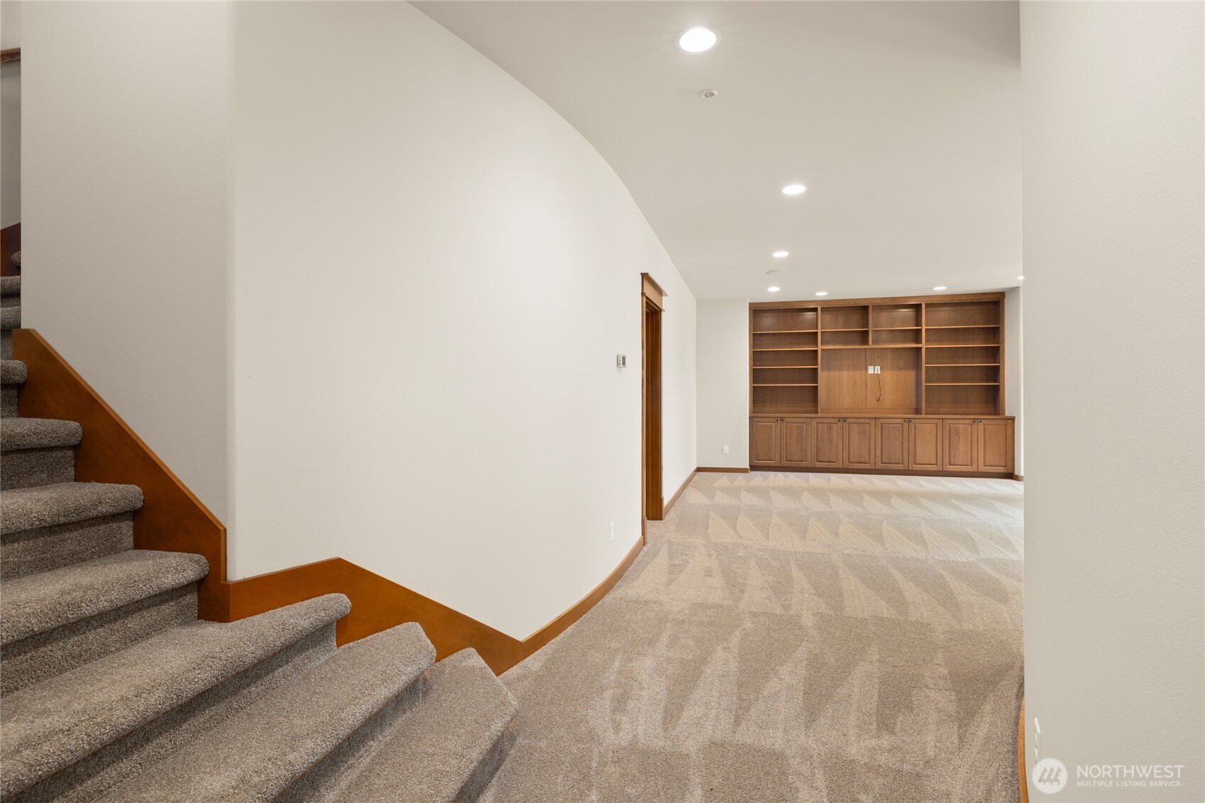 Down the stairs to a extra big bonus room. You could make this into a movie room or game room.