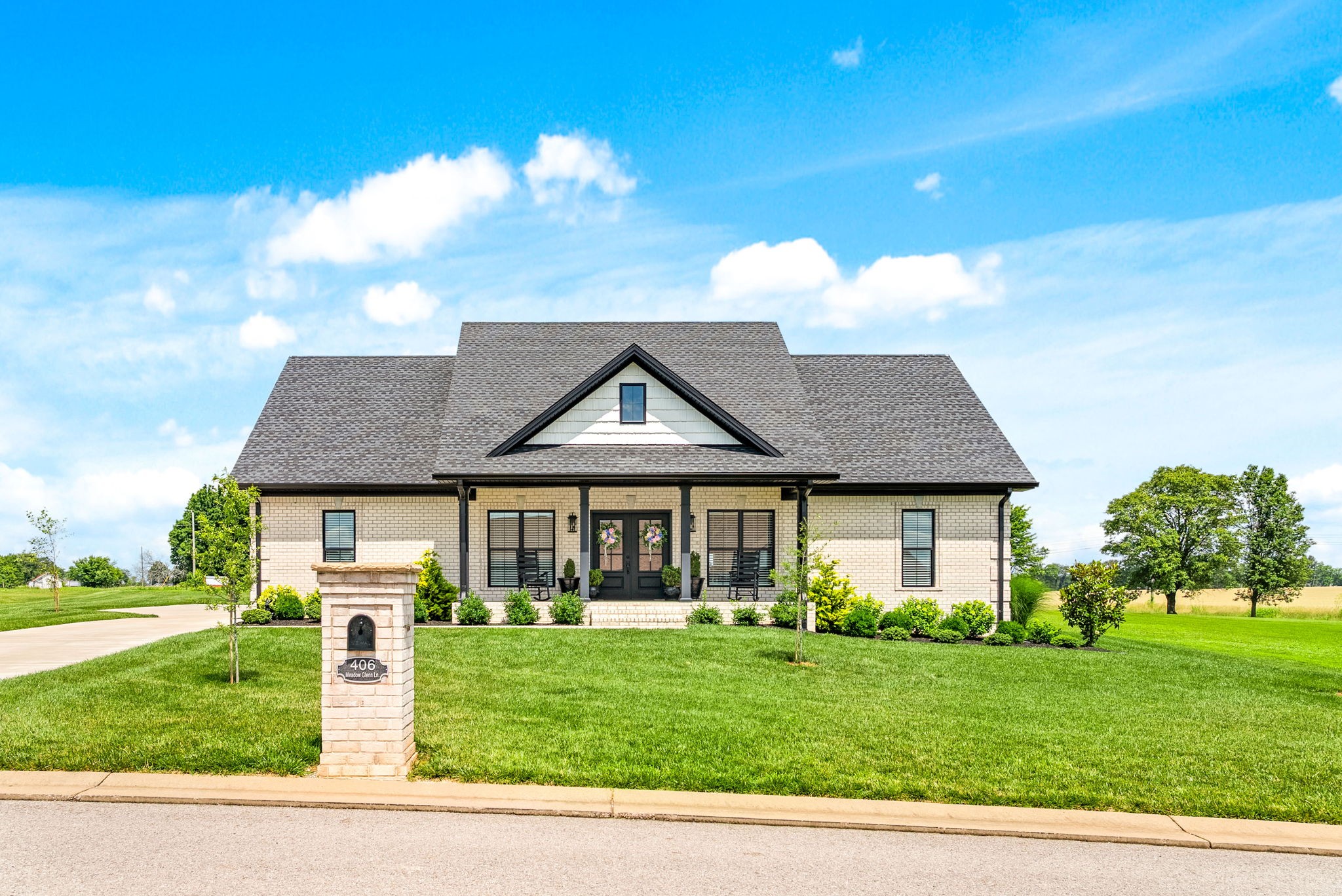 Get ready to have your socks knocked off with a whole house worth of southern charm! Every square foot of this custom all brick ranch was meticulously designed with premium materials & luxury features. As you pull into the driveway the curb appeal is stunning. Enjoy the grand covered front porch surrounded with beautiful landscaping and black beauty grass, proudly sitting on a level 1 acre lot. Moving inside, the wide plank finished hardwoods and tile floors elevate every room as they compliment all the custom details in the trim work, crown moulding, custom cabinetry with hidden walk in pantry & luxury kitchen appliances, including a 6-burner gas range. This house is more than beautiful - it's been built from the ground up with many functional features. The home comes equipped with a fully encapsulated crawlspace, an energy efficient spray foam roof and other areas of the house, two 200 amp electrical panels, tankless water heater, an ample amount of extra indoor and outdoor electrical plugs, wired preparation for a backup generator, and a massive storage area above the garage with easy to navigate stairs.
