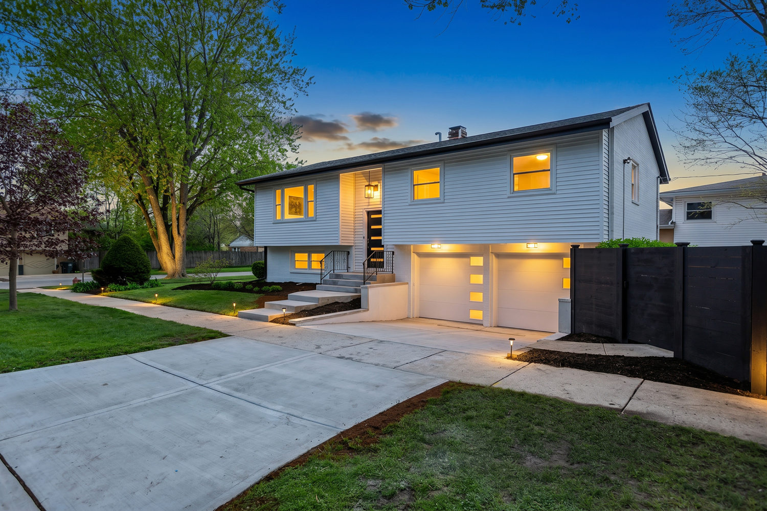Fully done from A to Z - this completely reimagined split-level is a showpiece of high-end finishes and modern luxury, set on one of the largest, fully gated lots in the Evanston school district. From the moment you arrive, the brand-new concrete driveway, custom staircase, and fully-fenced private grounds set the tone for what's inside.  Step into a sun-drenched, open-concept main level where designer finishes meet effortless flow. Three generously scaled bedrooms and three spa-inspired baths anchor a layout designed for both grand entertaining and everyday luxury. The living room - centered around a statement fireplace - opens seamlessly into the dining area and chef's eat-in kitchen, with doors leading out to a private porch made for morning espresso or evening cocktails.  The kitchen is a true centerpiece: custom white cabinetry, quartz countertops, a dramatic full-height backsplash, layered LED under- and in-cabinet lighting, and a full suite of Samsung stainless smart appliances. Every detail was curated - nothing was overlooked.  Retreat to the expansive primary suite featuring a private spa-style ensuite. All three bathrooms are finished to the highest standard with sleek modern vanities, quartz surfaces, rainfall showerheads, and imported European tile. Wide-plank hardwood floors, recessed lighting, and oversized closets carry through every room.  Multiple living spaces give this home rare versatility. The fully finished lower level delivers a sprawling second family room with a second fireplace, a custom wet bar, a dedicated laundry room, and abundant storage - the perfect lounge, media room, or entertainer's hideaway.  Outside, the fully gated grounds - among the largest lots in the area - offer privacy and presence rarely found at this price point. Add a 2.5-car attached, fully drywalled garage and the package is complete.  Ideally positioned near top-rated Evanston schools, premier shopping, and transit, with quick access to downtown Evanston, Old Orchard, the expressway, Northwestern University, and the Lake Michigan shoreline.  A turnkey, no-detail-spared offering - this one checks every box.