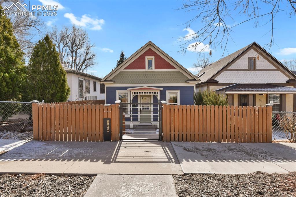 This turn-of-the-century home is straight out of a design magazine, blending timeless character with thoughtful modern updates. Built in 1894, this three-bedroom, two-bath residence has been meticulously remodeled while preserving its historic charm. Highlights include high ceilings, authentic hardwood floors, abundant natural light, and stylish modern lighting throughout. The spacious living room is large enough to accommodate an oversized foyer and dining area, creating a welcoming and versatile layout. The dining space features a custom built-in bench and opens seamlessly to the kitchen, making it ideal for entertaining and everyday living. The updated kitchen is a true showstopper, featuring custom green cabinetry with sleek black hardware, new fixtures, a large granite sink, under-cabinet lighting, classic subway tile backsplash, open wood shelving, stainless steel appliances, and a gas range. A charming spot for a breakfast nook sits in front of two corner windows, creating a light-filled space perfect for morning coffee. The main-level primary bedroom features hardwood floors and overlooks the deck with some mountain views. A custom modern staircase leads to the lower level, which offers a private additional bedroom, a full bathroom, and a dedicated laundry space. A large wood deck extends off the kitchen through French doors, perfect for indoor-outdoor living and entertaining. The fully fenced in lot offers alley access, a storage shed, and ample space to add a garage. The property is also zoned R-4, providing additional flexibility and potential. Additional parking in back of the house with ample room for RV parking.  Some property updates include A/C (2020), water heater (2020), roof (2012), updated kitchen, windows, electrical, interior/exterior paint, floors, railing, and lighting.  Enjoy quick accessibility to Shooks Run Trail and Switchback Coffee Roasters, walkability to downtown via Kiowa Street, restaurants, shopping, parks, schools and hospitals.