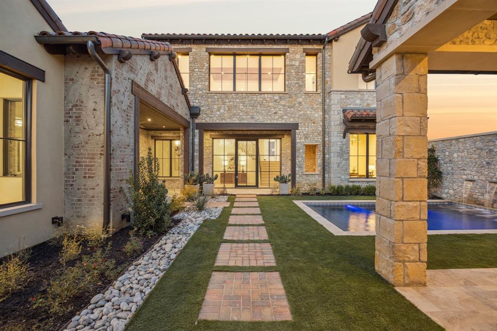 Discover the epitome of elegance in this Mediterranean-inspired masterpiece, crafted by renowned builder Heritage Homes, spans 5,098 square feet of artfully designed living space. Nestled in the coveted Westlake, Entrada neighborhood, this stunning two-story residence offers an inviting retreat for discerning buyers, featuring five generously sized bedrooms and five-and-a-half luxurious bathrooms.Upon entering through the private courtyard, be captivated by the seamless blend of sophistication and functionality. The expansive living areas are bathed in natural light, creating an ambiance of warmth and serenity. Entertaining is a delight with an outdoor kitchen, cozy fireplace, and a custom plunge pool with water feature. The home showcases unique cabinetry and stunning tile work throughout, each element meticulously crafted to offer a touch of modern elegance and timeless comfort that enhances the allure of each room.The gourmet kitchen is a chef's dream, equipped with stainless steel appliances, including a professional-grade 48-inch gas range, a 60-inch Thermador refrigerator freezer, a wine fridge, and a prep kitchen with a sink, ice maker, and second dishwasher. Retreat to the gorgeous private master suite featuring custom cabinets, freestanding soaking tub, and custom walk-in closet.Additional features include a laundry room with built-in storage and dog wash, optional space for an elevator lift from the garage level to the first floor. This home is a harmonious blend of luxury and practicality, ready for you to secure your piece of paradise today. Zoned for both Carroll ISD and the International Baccalaureate Westlake Academy.