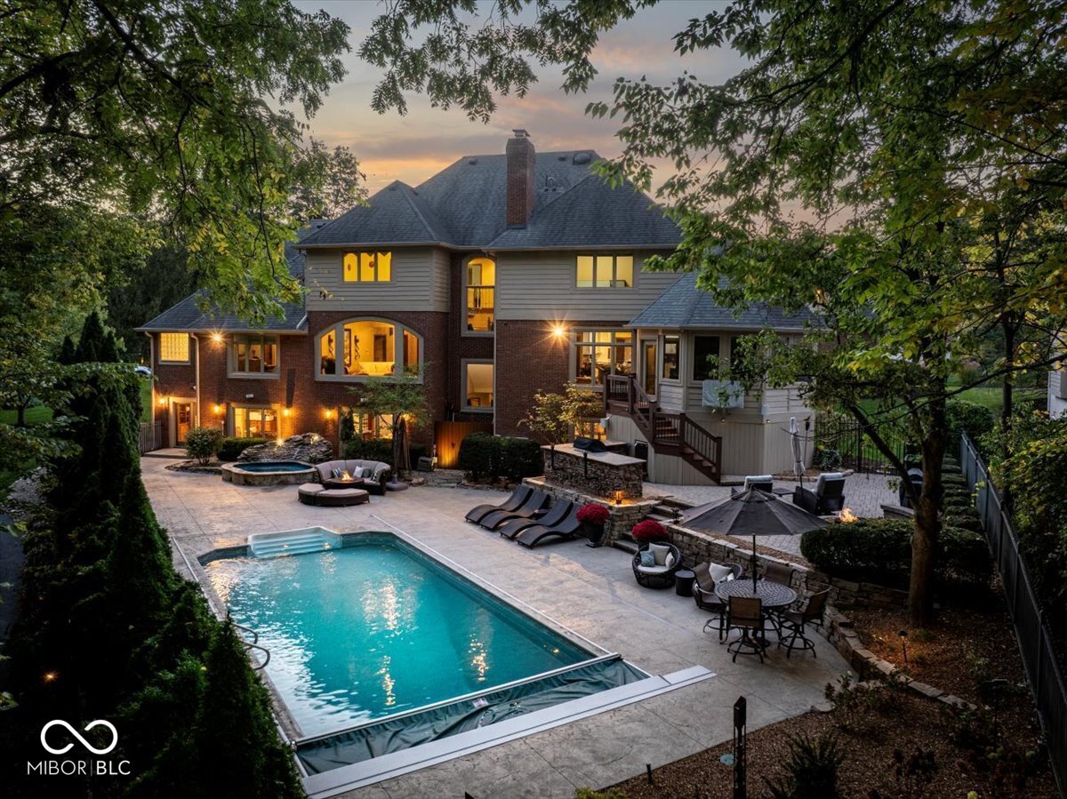 MAGNIFICENT NEW LISTING IN GATED NEIGHBORHOOD, ANCHORAGE! Nestled on PRIVATE .46 acre homesite w/gorgeous 30x20' SWIMMING POOL, seasonal GEIST WATERFRONT VIEWS & deeded BOAT DOCK just steps away! This stunning custom estate offers nearly 7,800 sq ft, up to 7 bedrooms, 6 baths, 1,000+ SQ FT GUEST WING, main floor owner suite, 3 fireplaces, 4 CAR GARAGE, several custom updates & 5 star location! The main level offers 10' ceilings, a stately office w/built-in cabinetry, gas fireplace (accessible to the owner suite), spacious 16' dining rm, large living rm w/floor-to-ceiling windows & easy access to a fully equipped gourmet kitchen (was remodeled by Sellers) & includes a center island, coffee nook w/espresso machine, prep sink, warming  drawer, drink fridge & ice maker, 10' DEEP WI PANTRY w/custom cabinetry, Miele, Subzero & Dacor appliances & open to a breakfast nook & cozy hearth rm w/fireplace, built-in's & access to a cozy 15' three seasons rm w/17' ceiling! The SPACIOUS MAIN LEVEL OWNER SUITE features a wall of windows, double tray ceiling & luxurious/remodeled spa bathroom w/heated floors, dual vanities, a multiple head steam shower, free-standing tub & custom 12x10 WI closet. THE UPPER LEVEL includes 4 XL bedrooms, each w/access to a full bathroom & WI closet + a PRIVATE APARTMENT w/fully equipped kitchen, office/dining nooks, living rm, 6th bedrm, full bath & laundry rm. PERFECT FOR GUESTS, IN-LAWS OR MOOCHING KIDS! The WALKOUT lower level is perfection w/42' rec area, 15' wine cellar w/tasting rm, exercise rm w/SAUNA & STEAM SHOWER (could be 7th bedroom), a full bar w/ice maker, dishwasher, drink fridge & open to a gorgeous family rm w/fireplace & built-ins. NEED STORAGE SPACE? There's plenty on ALL 3 LEVELS! The fully fenced-in BACKYARD OASIS features a/beautiful pool, hot tub/waterfall, fire pit, grill station w/drink fridge & spacious paver patio! Bike to shopping, dining, coffee shops, marina & miles of paved walkways! OPEN HOUSES FRI 4-6PM, SAT & SUN 12-2.