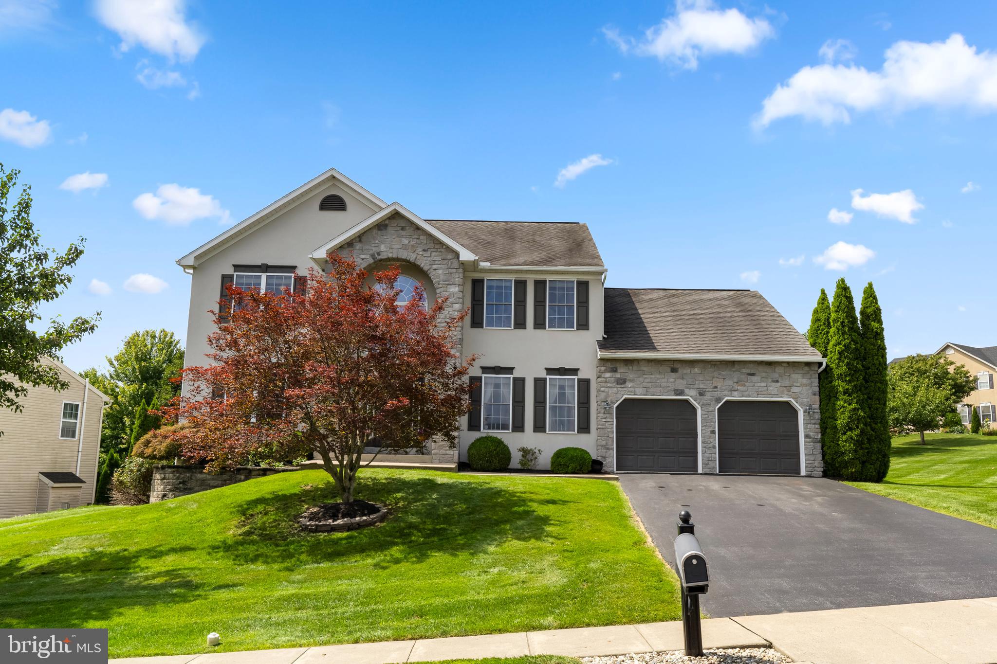 Welcome to 236 Buckhead Lane, a beautifully maintained 4-bedroom, 2.5-bath Colonial on a generous .38-acre lot in the desirable Sunset Knoll community of Douglassville. From the moment you arrive, the beautifully landscaped property, mature trees, manicured lawn, and welcoming curb appeal set the tone for a home that has been thoughtfully cared for and enjoyed.  Sunset Knoll offers a wonderful neighborhood setting while remaining conveniently close to shopping, dining, and major routes including Route 422.Step inside the impressive two-story tile foyer, where the spacious and inviting layout immediately makes you feel at home. The formal dining room features newer carpeting and crown molding, while the front living room provides a comfortable space for relaxing or entertaining.The heart of the home is the beautifully updated kitchen, featuring newer luxury vinyl flooring and stainless-steel appliances installed in 2022. The kitchen offers granite countertops, gas cooking, a double sink, a convenient coffee bar, a breakfast area, and even a built-in griddle on the range. Storage is exceptional with two pantries, including an extra-large walk-in pantry that provides plenty of room to keep everything organized.Just off the kitchen, the spacious family room is designed for everyday living and entertaining, featuring a gas fireplace and sliders leading directly to the deck and backyard. The large mudroom is another standout feature, with convenient access to both the backyard and the garage, along with a washer, dryer, and laundry sink.Upstairs, the spacious primary suite provides a wonderful retreat. The oversized closet area is so generous that it includes its own sitting area, creating a flexible space for dressing, relaxing, or organizing your wardrobe. The private primary bath features a jetted soaking tub, separate shower stall, double sinks, and recessed lighting with a dimmer. Three additional generously sized bedrooms offer ample closet space and ceiling fans, along with a full hall bath.The unfinished basement provides valuable storage and utility space and includes a water softener, dehumidifier, whole-house humidifier, and radon remediation system.And for those who need great garage space, this home delivers! The oversized two-car garage features durable rubber tile flooring, garage door openers, and a convenient bump-out that provides additional storage space—perfect for tools, bikes, lawn equipment, or all of the extras that come with everyday life.With its beautiful .38-acre setting, sought-after Sunset Knoll location, spacious floor plan, updated kitchen, generous storage, and convenient access to Route 422 and nearby shopping, 236 Buckhead Lane offers the ideal combination of comfort, space, and convenience in Douglassville. This is a home you'll want to see in person!