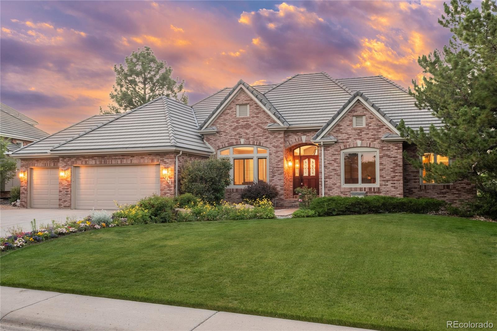 Nestled on a quiet cul-de-sac in the highly sought-after Mansion Hills community, this exceptional semi-custom UPDATED ranch- style home sits on a sprawling lot surrounded by mature trees, breathtaking mountain views, and spectacular Colorado sunsets. Thoughtfully updated throughout, this home perfectly blends timeless elegance with modern sophistication. Step inside to discover a private study on the main level-featuring custom built-ins and beautiful front-facing windows, an inviting formal dining area and a spacious great room anchored by a cozy fireplace and framed by picturesque windows that showcase the home's stunning surroundings.The beautifully remodeled kitchen is a chef's dream, offering gorgeous quartz countertops, top-of-the-line appliances including an induction cooktop and warming drawer, a walk-in pantry, and a sunny breakfast nook with direct access to the expansive new deck—ideal for entertaining or simply enjoying the peaceful outdoor setting. The main-floor primary suite serves as a luxurious retreat, complete with private deck access, a fully updated spa-inspired bath, and a generous walk-in closet.The walkout lower level is designed for both relaxation and recreation, featuring an expansive family room with wet bar, dedicated fitness area, dry sauna, three spacious secondary bedrooms, and two beautifully renovated bathrooms.With extensive updates, exceptional living spaces, and an unbeatable setting, this remarkable home offers a rare opportunity to enjoy the very best of Colorado living. From the moment you arrive, you'll understand why this is a home you'll never want to leave. Welcome home!