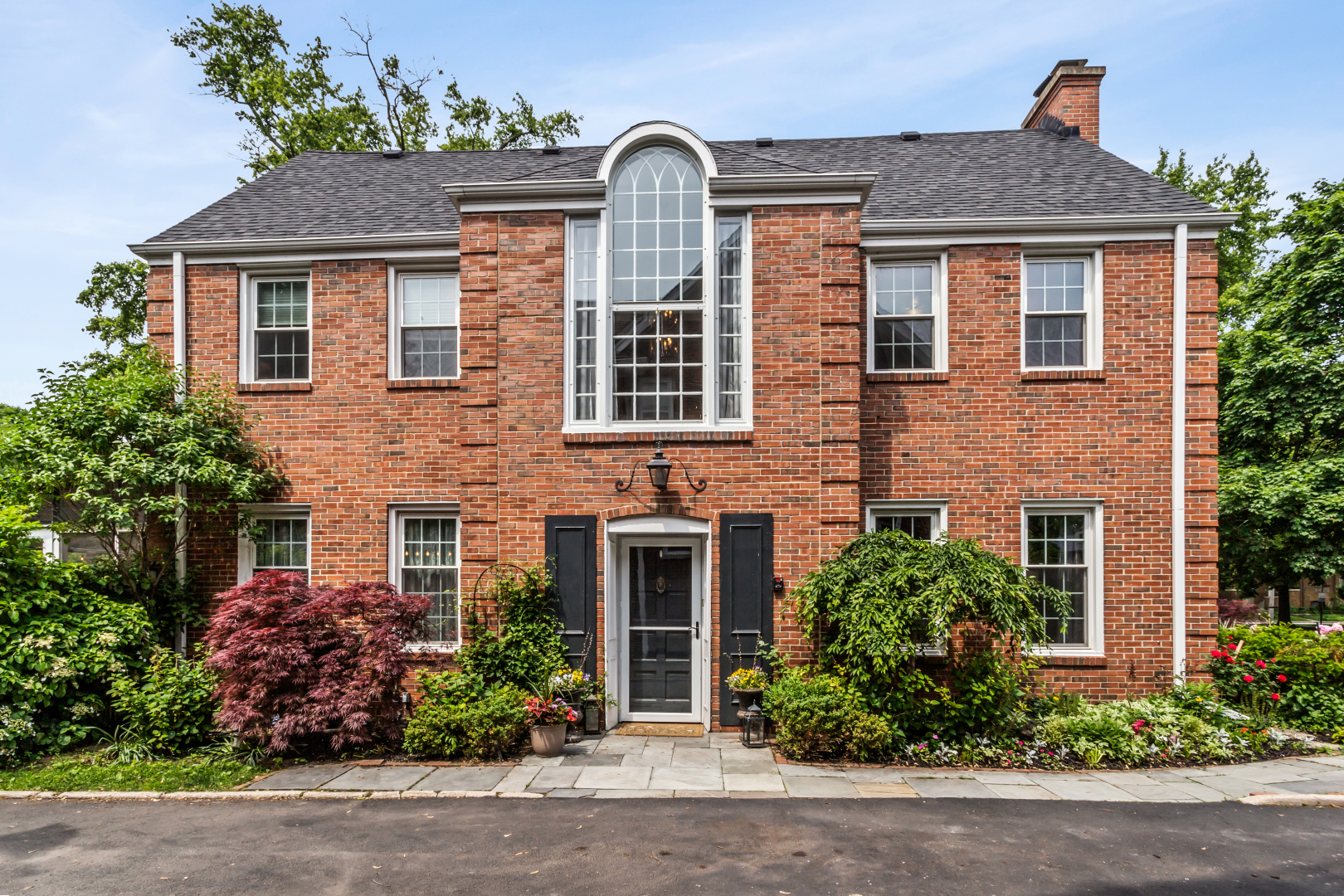 Timeless elegance meets prime location in this classic English brick beauty, nestled on the golf course in sought-after Northeast Evanston. From the moment you enter, you're greeted by a grand foyer and dramatic staircase framed by a soaring two-story Palladian window that floods the space with natural light. The expansive living room, surrounded by windows on three sides, offers flexibility for multiple seating areas-ideal for both relaxing and entertaining. The formal dining room comfortably accommodates a table for ten, perfect for hosting gatherings. The kitchen provides excellent workspace and abundant cabinetry, with a cozy breakfast nook overlooking the beautifully landscaped yard. A main-floor den with a full en-suite bath can easily serve as a sixth bedroom or private guest suite. Upstairs, the generous primary suite features a spacious bedroom, inviting sitting area, and an updated en-suite bath. Two additional bedrooms share a well-appointed hall bath. The third level offers two more bedrooms and a fourth full bath-ideal for guests, a home office, or creative spaces. The finished lower level includes a large recreation room perfect for movie nights or game days, along with a sizable laundry room, abundant storage, and a convenient walk-out door.But it's the outdoor space that truly steals the show-multiple decks and patios, lush gardens, and a detached two-car garage create a private oasis. Step through the rear gate and find yourself directly on the golf course, with sweeping views of the greens at your doorstep.This is more than a home-it's a lifestyle.