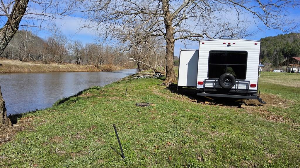 Escape to the beauty of Southwest Virginia with this rare riverfront opportunity at 18655 Riverside Drive in Fries, VA, located in scenic Grayson County. Offering approximately 2.38 acres along the river, this property is the perfect setting for a private getaway, recreational retreat, or potential Airbnb investment. Whether you're looking to unwind or create an income producing property, the possibilities here are wide open.  Enjoy direct access to the river where you can spend your days tubing, kayaking, fishing, or simply relaxing by the water. The peaceful surroundings and natural beauty make it an ideal spot for family gatherings, camping, and making lasting memories. This property is located in a highly desirable area known for outdoor recreation and its popularity among campers and nature lovers. The property is available with the existing camper included, making it move in ready for immediate enjoyment, or it can be purchased at $135,000 without the camper if you prefer to bring your own vision to life.  Grayson County is well known for its incredible outdoor attractions, including Grayson Highlands State Park, home to the famous wild ponies and breathtaking mountain views, and the scenic New River Trail State Park, perfect for hiking, biking, and horseback riding along the historic New River. Nearby, the charming town of Fries offers small town appeal with a rich history, local events, and easy access to the river. If you've been searching for a peaceful riverfront escape with recreation right at your doorstep, this property is a must see.