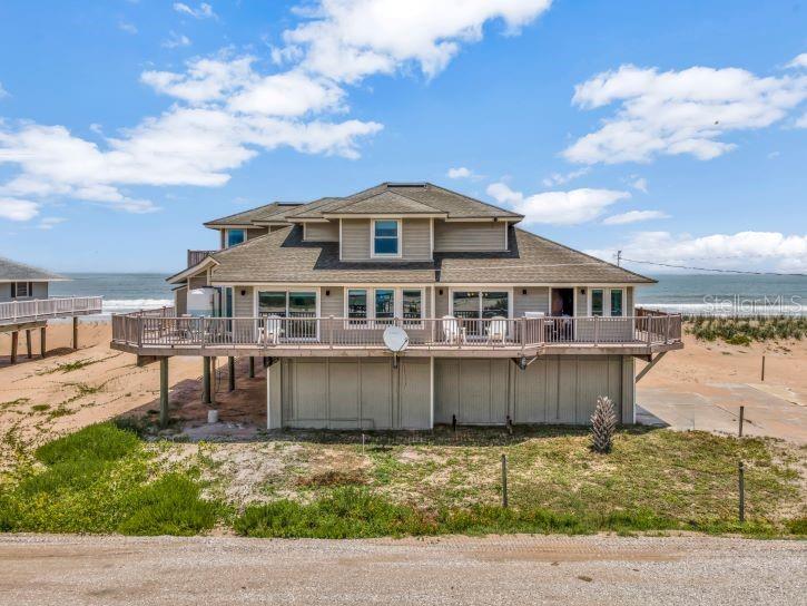Welcome to a once-in-a-lifetime opportunity to own a truly exceptional seaside home in the highly coveted and private Summer Haven community. Brand new roof August of 2026! Nestled along a quiet, private road with no public beach access, this direct oceanfront estate also boasts rare river frontage—offering breathtaking panoramic views of both the Atlantic Ocean and the Summer Haven River. Designed to maximize its stunning surroundings, this 4-bedroom, 3-bathroom coastal retreat features a wrap-around porch where you can savor both sunrises over the ocean and sunsets over the river. Every room in the home offers a view, filling the space with natural light and the soothing ambiance of coastal living. The open-concept kitchen is a chef’s dream, showcasing elegant granite countertops, top-of-the-line appliances—including a Viking refrigerator—and plenty of space for entertaining. Their are 2 owner’s suites with unparalleled ocean views, spa-inspired bathrooms with dual vanities, large walk-in showers, and spacious walk-in closets. Additional highlights include a 3-car garage with storage space, spacious guest bedrooms with ocean or river views, and seamless indoor-outdoor living spaces that embrace the unique beauty of this rare location. This is more than just a home—it's a lifestyle of privacy, luxury, and unmatched natural beauty. Opportunities like this in Summer Haven are incredibly rare. This property would also make for a great Short Term Vacation Rental! Don’t miss your chance to own one of the most unique properties on Florida’s coast.
