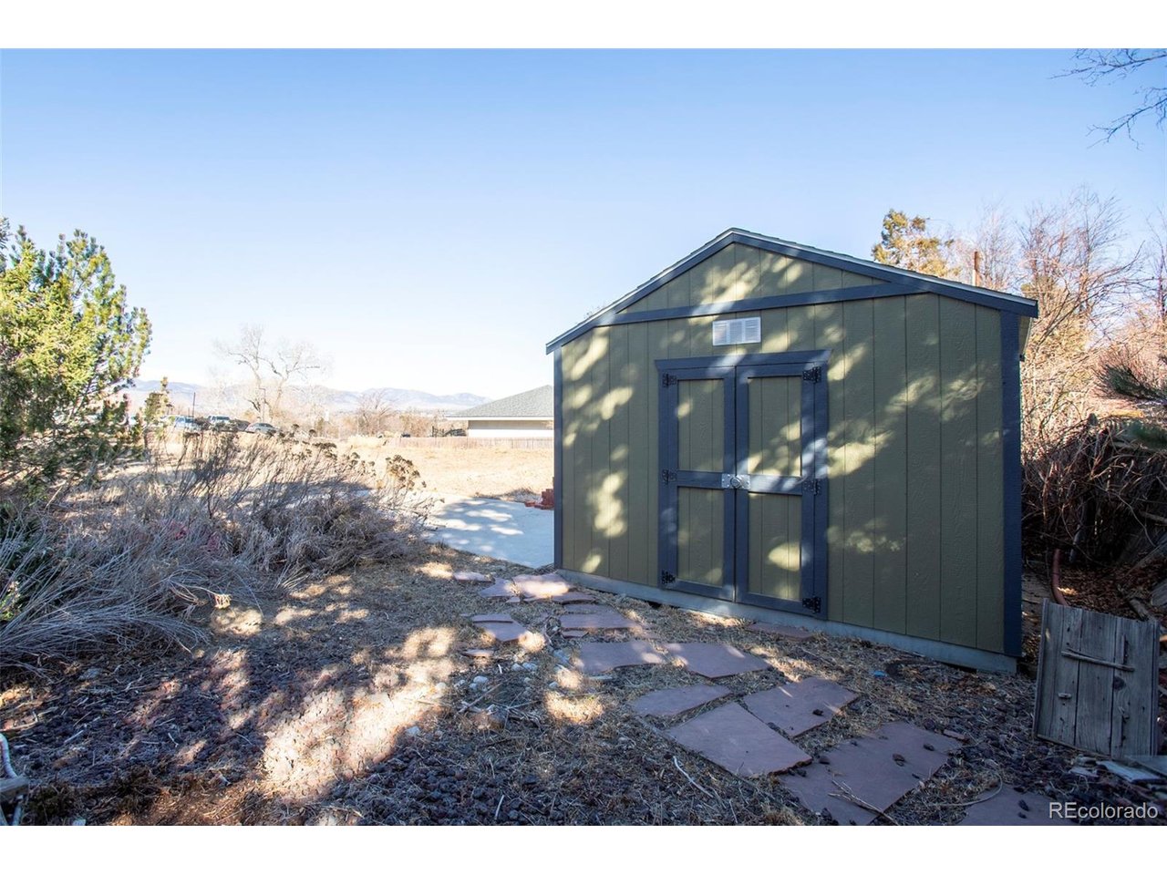 PRICE IMPROVEMENT !!  "Great investment potential"  Escape to your private, secluded oasis with SPECTACULAR views in the heart of desirable Wheat Ridge, situated at the foot of the Rocky Mountains.  Come explore this rare opportunity to own 0.63 acres, a single R-2 property that can be sub-divided into two R-2 zoned lots, ideal for redevelopment. The back lot measures approximately 150 ft. deep and 100 ft. wide.  You could build your Dream Home and/or have the hobby farm you always wanted, so bring your horse, goats, and chickens!  The whole property is irrigated by well water, so no watering restrictions!  The home was custom built in 1964, and is still owned and occupied by the original family.  There are many custom features as well as updates & improvements to the home.  New Evaporative Cooler installed 7/26.  A new Dukane boiler was installed in mid-2021, along with new bathroom fixtures, new window treatments, and new bathroom floors.  The basement is pre-plumbed for an additional bathroom, a custom built cedar closet under the stairs, and finished laundry room with cupboards and sewing area.  The entryway has Bottle Glass in the window near the front door and the flooring has beautiful porcelain tile with brass accents.  The kitchen flooring is solid oak plank, with custom cabinetry throughout the home.  The dining room features a custom built-in oak China Cabinet, solid oak coffering and room partition with custom lead-glass panes.  The sun room sits on a solid slab and has a moss rock fireplace and cooking area, with a JennAir cooktop, grill, and rotisserie, and comes with a 2nd set of news accessories.  The mature landscaping gives this property the utmost in privacy.  5G cable was recently installed in the area, close to schools, shopping, rail transit & walking trails, all which make this property a hidden gem waiting for you to find!!  The property is being sold "AS IS".