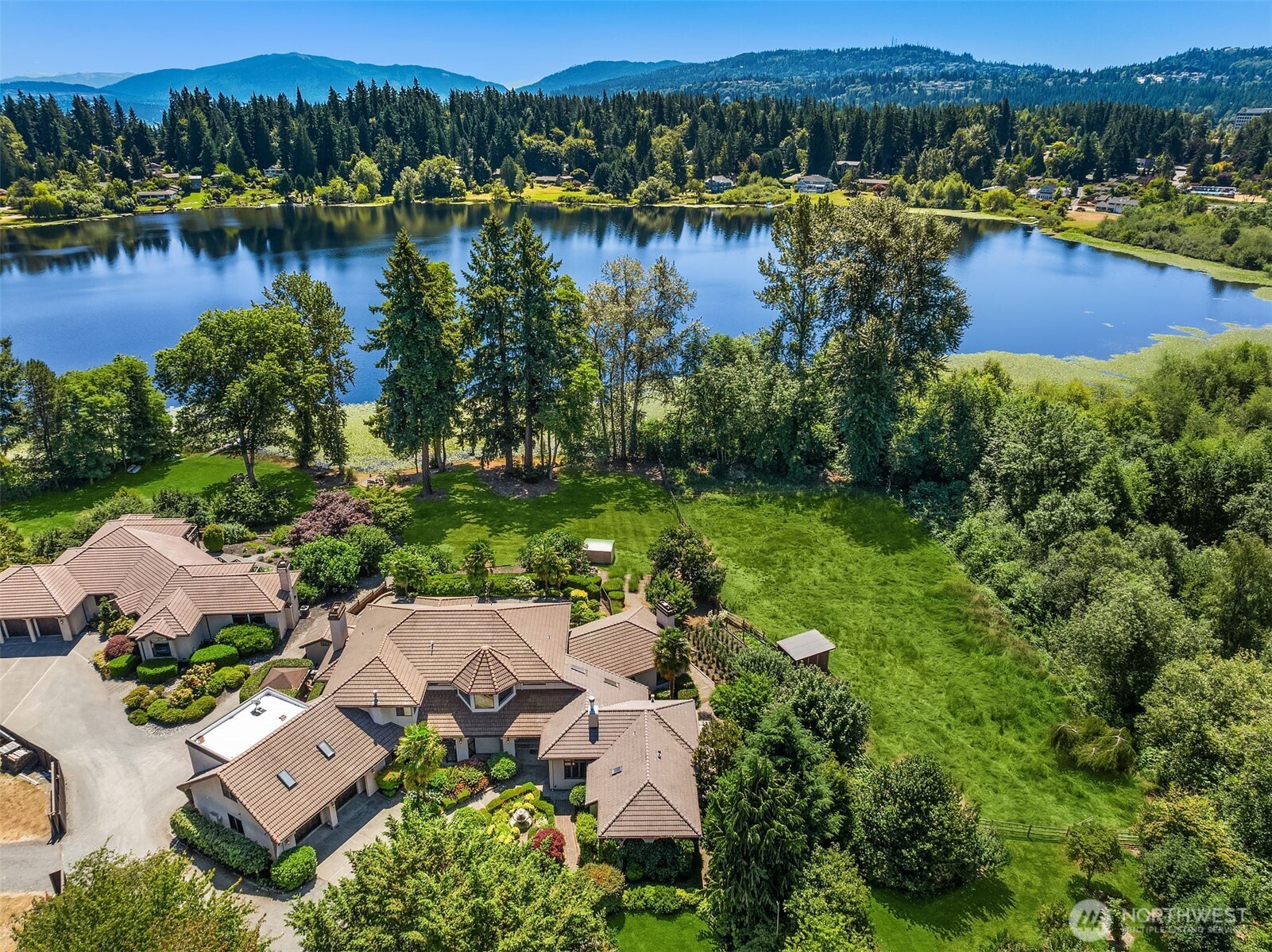 Legacy estate in a storybook setting… First time ever on the market, this extraordinary 5.7 acre retreat offers 150 feet of peaceful Phantom Lake waterfront in the heart of Bellevue. A tree-lined drive leads to an 8,240 square foot custom masterpiece by renowned builder John McHugh. Two luxe primary suites (entry-level and upper floor), plus 2 additional bedrooms, 5.25 bathrooms, a swimming pool, fruit bearing orchard, lush gardens, and expansive lawn-to-lake grounds create rare privacy and natural beauty with massive indoor and outdoor entertaining spaces flowing seamlessly throughout.. A once-in-a-generation lifestyle property—unmatched in scale, serenity, and soul. Live as-is or create your dream…