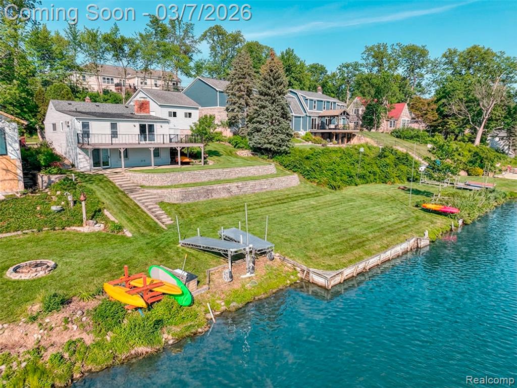 This is more than a home — this is a rare waterfront legacy and lifestyle. A truly rare offering on the coveted Fonda Lake. This extraordinary all sports lakefront residence presents 80 +/- feet of pristine water frontage on one of Brighton’s most desirable lakes. Opportunities on this low-turnover lake are few and far between. Perfectly positioned on a double lot, this refined ranch home offers beautifully finished entry level living space, designed to embrace simplicity, comfort and panoramic lake views. Expansive windows bathe the interior in natural light, while the open planned design creates a seamless flow for both everyday living and romantic entertaining. At the heart of the home, a double-sided fireplace anchors the main living areas, creating warmth and architectural distinction. The walkout level features an additional fireplace, bedroom, bathroom and finished living space, offering effortless access to the waterfront and endless possibilities for recreation or relaxation. Step outside to an impressive composite deck overlooking the tranquil waters of Fonda Lake — an idyllic setting for sunset dinners, morning coffee, or hosting lakeside gatherings. The generous grounds provide exceptional privacy, abundant green space, and a flexibility for future enhancements. This three bedroom, three bathroom residence is thoughtfully appointed with hardwood flooring, spa-inspired bathrooms, and a luxurious jetted tub. Storage is abundant throughout, and complemented by a 2.5-car garage. In addition to the paved driveway, a separate paved parking area accommodates four + vehicles — ideal for hosting or storing recreational equipment. Located within the Brighton School District, this distinctive lakefront property offers the perfect balance of luxury, lifestyle, and location. Just a skip away from all downtown Brighton  offers. Showings permitted only by appointment. Photography has been virtually staged for interior design. All measurements and lot lines estimated.