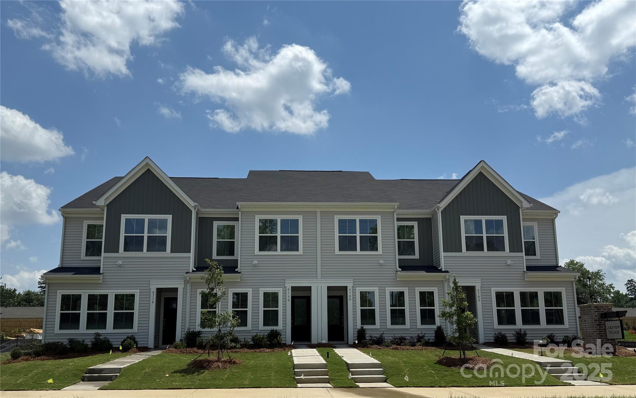 Discover the charm of this boutique townhome community built by Mungo Homes, a leader in quality craftsmanship & luxury design. This fabulous two-story townhome called the Cannalily features 3 bedrooms, 2.5 baths, & a rear-entry one-car garage, offering an open-concept layout w/ designer touches throughout. The main floor boasts luxury vinyl plank flooring, creating a seamless flow through the bright & airy living spaces. The chef’s kitchen is a standout, featuring a large sitting island w/ granite countertop, stone gray cabinetry, tile backsplash, pendant lighting, & SS appliances! Upstairs, the spacious primary suite impresses w/ a boxed ceiling, generous walk-in closet, & a en suite bath w/ a quartz-topped dual vanity & a tiled walk-in shower. Two additional bedrooms, a full bath, & a convenient laundry closet complete the second level. Located just minutes from Uptown Charlotte, the airport, & shopping, Lakeview Village offers the perfect blend of style, comfort, & convenience!