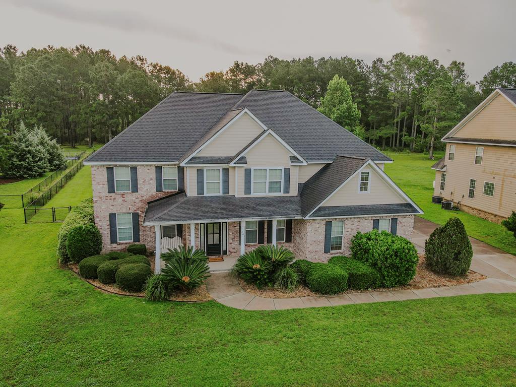 Welcome home to this stunning, light-filled brick residence located in the highly desirable Sweetbriar Subdivision! Offering an impressive 3,529 square feet of quality craftsmanship, thoughtful details, and spacious living, this home has everything today's family needs—and so much more.       Step inside the warm and inviting Main Level to a sunlit, open flow perfect for both everyday living and entertaining. The elegant formal dining room showcases gorgeous coffered ceilings, while the cozy fireside family room serves as a central gathering place.  The connecting Kitchen is designed for effortless meal prep and entertaining, featuring a spacious center island, sleek granite countertops, and a generous pantry for optimal storage.  Enjoy the privacy and convenience of a retreat-style downstairs master suite—your peaceful escape at the end of the day.   Upstairs, you'll find four generously sized bedrooms, providing plenty of room for family, guests, or flexible space.  Host unforgettable movie nights in your very own upstairs media room, complete with a projector and screen!   Step outside to a large, fully fenced backyard—ideal for summer BBQs, pets, and outdoor play.  Quality craftsmanship and extra custom touches shine throughout every corner of this property. Schedule your tour today to experience everything this beautiful Sweetbriar home has to offer!
