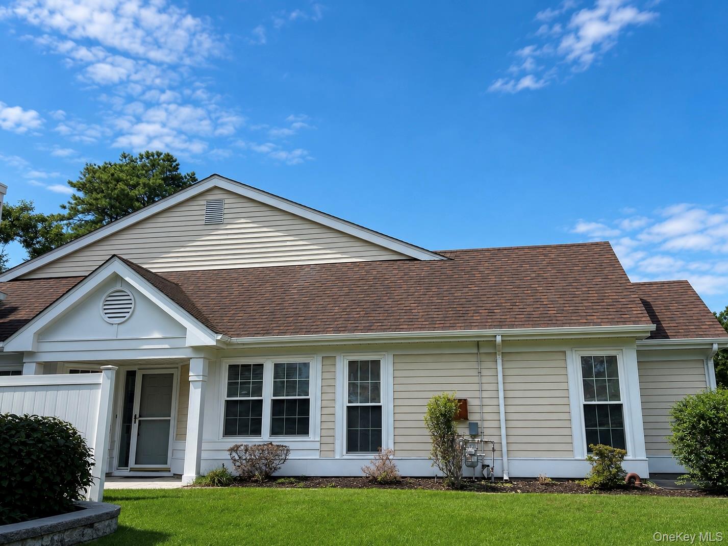 Wonderful opportunity in the highly sought-after community of Leisure Glen. The Greenport model stands out as the largest model, featuring a spacious living room with a cozy gas fireplace, a versatile, expanded den/greenery room, eat-in kitchen, dining room with high vaulted ceilings and skylights, guest bedroom, updated guest bathroom, and primary suite with full bathroom and his-and-hers closets. HVAC system was updated in 2020 ensuring year-round comfort. Step outside to the shady back yard with brick patio. Perfectly situated near the end of the cul de sac and a just a short stroll to the beautiful clubhouse, outdoor pool, peaceful paseo, tennis, pickle ball, and more! This is truly vacationing at home all while being close to North Fork's local farm stands, beaches, and wineries. Don't miss your chance to experience the best of vibrant, retirement living!