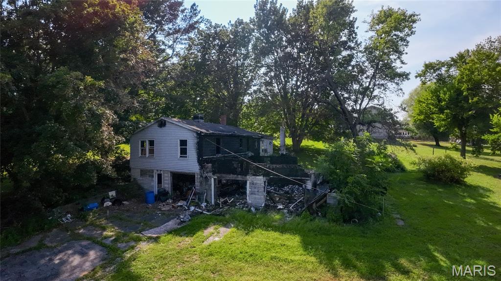Opportunity awaits!  This property sits on a spacious +/-.89 acre lot with some mature trees and is just a short walk to schools and grocery stores.  Property is being sold AS-IS!  Prospective buyers and agents should exercise extreme caution around structure.  Enter at your own risk!  Neither Seller nor Seller's Brokerage assumes responsibility for any accidents or injuries on the property.