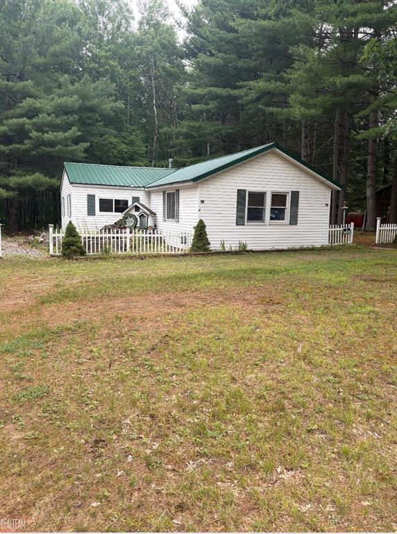 Are you looking for that perfect  cozy, warm cabin to escape the everyday hustle.  It's a place where you can truly make it your own. The 2 car garage is equipped with electricity and heat. Peaceful and welcoming vibe just minutes away, you're surrounded by endless outdoor  activities.  Whether it's winter snowmobiling or enjoying summer days, tubing and canoeing along serene waters.  Just minutes from Skidway lake and 15 mins from West Branch.