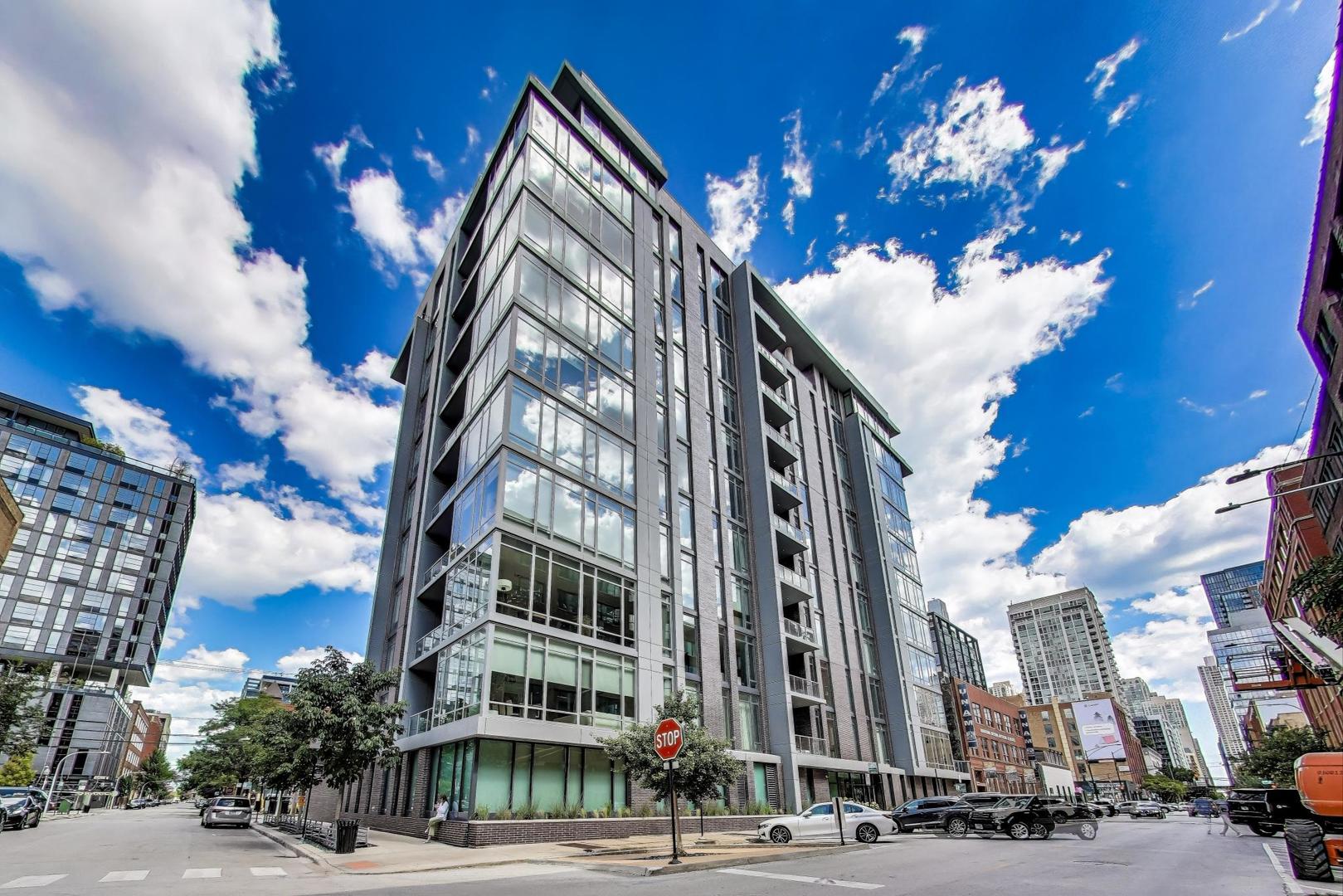 Elevate your lifestyle in this expansive 3-bedroom + den, 3-bathroom high-floor Southeast corner residence at 360 W Erie - one of River North's premier boutique luxury buildings. Spanning 2,300 sq ft, this home is a masterclass in modern elegance with floor-to-ceiling windows framing panoramic skyline views from every room.  Thoughtfully designed with 10' ceilings, 8' solid core doors, and wide plank hardwood floors, the open-concept layout seamlessly integrates spacious living and dining areas - perfect for both everyday living and upscale entertaining. A custom entertainment center with under-cabinet lighting and a hidden TV cabinet anchors the living room with sophistication.  The chef's kitchen features custom Italian inset cabinetry, a mitered-edge waterfall island with seating for four, Wolf and Sub-Zero appliances, and a full-height slab backsplash that exudes luxury. Two private balconies extend your living space - one off the dining area for effortless hosting, and another off the primary suite, ideal for your morning coffee ritual.  The floor plan includes a versatile den with built-in bookcases, perfect for a home office, library, or quiet study - offering both form and function to meet today's lifestyle needs. Retreat to the luxurious primary suite featuring three closets (including two walk-ins) and a spa-inspired bathroom with a dual vanity, makeup counter, glass-enclosed shower, and separate water closet. The second bedroom includes an en-suite bath and walk-in closet, while the third bedroom is spacious and features eastern skyline views. A fully built-out laundry room with front loading washer/dryer has ample storage and folding area. Smart upgrades include custom Lutron motorized window shades in all rooms along with a full height Sub-Zero wine fridge for modern convenience Two heated garage parking spaces available for purchase 100k. Built in 2019 by Belgravia, this boutique 38-unit building is nestled in a quiet residential enclave of River North. Residents enjoy a rooftop sundeck, fitness center, party room, dog run, and secure access in a prime location close to galleries, dining, the riverwalk, and more.