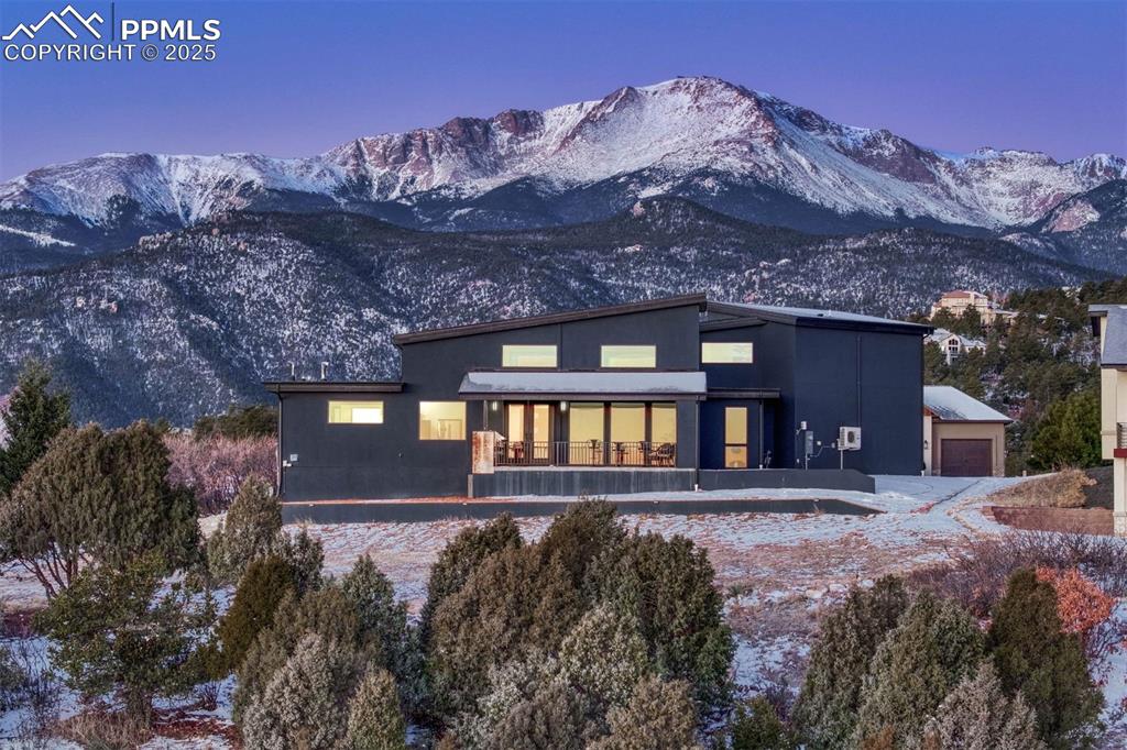 Wake Up to Pikes Peak – Live a Day of Delight in This Private Colorado Haven! Imagine beginning your day with coffee in hand, watching the first light of sunrise paint Pikes Peak in shades of gold and rose. This modern masterpiece, nestled in an exclusive gated community just minutes from Old Colorado City and Manitou Springs, offers not only breathtaking panoramic views of the Front Range and city below, but a lifestyle of effortless luxury and privacy. Step inside to discover refined main-level living with high-end finishes that blend modern elegance with timeless comfort. The open-concept design flows seamlessly from a chef-worthy kitchen to a spacious great room, where floor-to-ceiling windows frame the mountain and city panorama. Whether you’re working from home or curling up with a book, every room offers a moment of serenity. As the day unfolds, lace up your shoes and access nearby trails that wind through red rock formations and breathtaking forests—ideal for a morning hike, bike ride, or peaceful meditation among nature. Then stroll through the vibrant boutiques, cafés, and galleries of Old Colorado City or explore the charm of Manitou Springs just minutes from your door. Come afternoon, relax on your expansive terrace, firing up the outdoor grill in your custom cooking space. Prepare dinner with fresh local ingredients while the sky shifts to dusky violet, casting the city lights below into a shimmering mosaic. Invite a friend or savor the quiet—this home is designed for both intimate evenings and effortless entertaining. As night falls, unwind under a blanket of stars, the mountains silhouetted against a moonlit sky. It’s more than a view—it’s an experience that elevates every moment. This is Colorado living at its finest: peaceful, private, and perfectly connected to nature and culture alike. Whether you’re seeking a serene retreat or a dynamic lifestyle, this home delivers it all—with a view you’ll never stop falling in love with.
