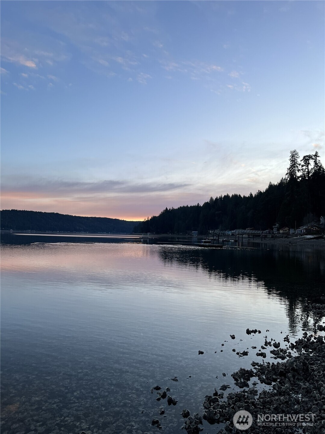 Story book waterfront cabin on the coveted North Shore of Hood Canal! Open the gate and enter into this hidden treasure and enjoy all of the waterfront living and the recreational fun it offers. Dig for clams, grab a few oysters and keep an eye peeled for orca whales or grab a paddle board and immerse yourself in another world. Every day feels like a vacation. Approx 78 ft of bulkheaded waterfront & tidelands. Additional property across the road including room for parking. Many recent improvements include NEW plumbing, electrical panel, flooring, interior paint and a large new composite deck. Entirely new septic system in 2021. Southerly facing for year around sunshine. Large view windows frame this ever-changing wildlife spectacle that is perfect for the little quiet getaway, entertaining friends or a great investment as a vacation rental? Great fishing, shrimping, waterskiing, swimming and trails for dirt biking and hiking only minutes away. If you are an outdoor enthusiast, this is for you.  Less than an hour and half from Seattle. You have finally found the magical waterfront cabin that is affordable.