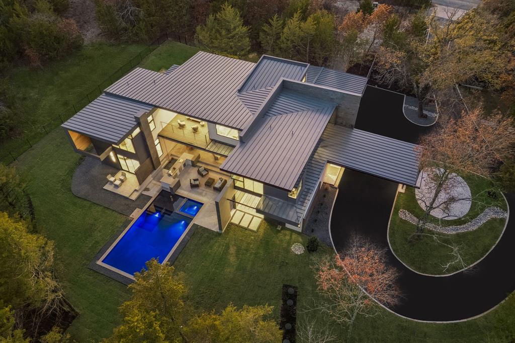 Imagine that your drive home is one of the highlights of your day. While others endure the stress of their commute, you veer off the main thoroughfares towards a home that was created to restore balance and harmony in life. A home so intentional that it’s taken more than a decade to realize.  Welcome to “Harmony House.”   An elite sanctuary that integrates masterful architecture with the beauty of nature.  Only 45 minutes from the heart of Dallas, a winding road ventures through the trees, alongside a stream and past a quaint winery. This evokes a sense of rejuvenation expected from a luxury vacation retreat. Entering  the private drive to your 2 acre, heavily wooded estate, you are reminded that THIS is what you’ve worked for.  Inspired by the philosophies of Frank Lloyd Wright, this architectural gem captures the essence of nature in every room. It indulges the senses with the healing sounds, scents and imagery of the forest; while offering the sophisticated amenities of an architect designed modern home.  The gentle rolling terrain is home to more than 400 trees. A private nature trail winds through the trees to an outdoor cinema, dining area and sunset viewing perch. There are clearings in the woods for future cabins to be constructed to enhance the lifestyle of the residents. Inside, the floor plan offers flexibility beyond single family living. Whether used as a primary residence or a luxury vacation home, the property offers exquisite entertaining spaces, serene bedroom suites and multi-functional spaces that provide an array of uses. There are 3 living areas, 2 kitchens, 2 offices and a storm shelter. The house is prepped for an elevator & wine cellar.  Proximity to the new TKI Airport, makes this a valuable proposition for a family investment. Experience this property, created by an award winning design team: Private tours given to buyers with proof of funds. Semi private tours arranged monthly for up to 10 prospects. Reserve your tour today.