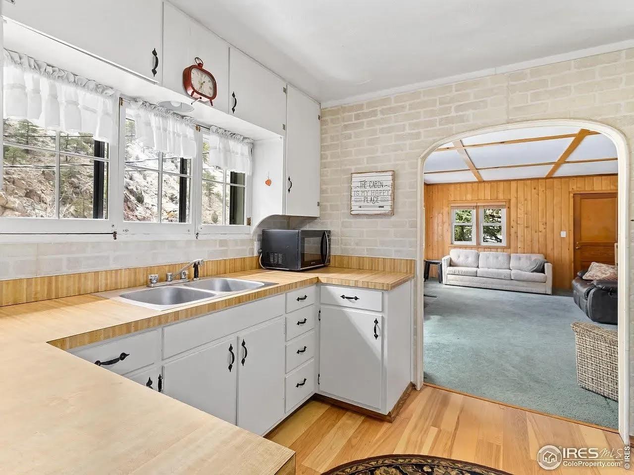 Nestled along the river's edge, this enchanting 3-bedroom cottage offers a lifestyle of tranquility and privacy. Inside, the functional layout is bathed in natural light, featuring a cozy country kitchen and a full bath with a vintage claw-foot tub. The lower level provides a versatile retreat for hobbies and gear storage. Step outside to discover a lush landscape, kept vibrant by included irrigation water rights. With two full lots, there is plenty of room to roam and breathe the crisp mountain air. Modern comfort is ensured with a brand-new heat pump system for heating and cooling, and the inclusion of all furnishings makes your transition to river life effortless.