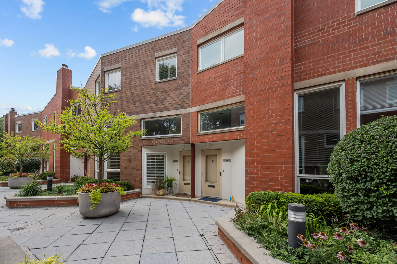 Don't miss this rare gem - a stunning 3 bedroom, 2.1 bath townhome in the coveted Evanston Terraces! Prepare to be wowed by the soaring ceilings, large windows, and the elegant custom built-ins, dry bar & wine fridge that greet you upon entering the main level. Past the charming Living Room & stylish Dining Room you'll be lured into the completely renovated Kitchen featuring high-end appliances and Quartz countertops & backsplash. Look out the plantation shutters from the adjoining cozy Family Room onto the private brick paver back patio surrounded by lush foliage. On the second floor you'll find the spacious Primary Bedroom with a fully renovated Primary Bath, complete with a custom glass shower, heated Kohler air tub & double sink. The top floor, sundrenched from the skylight, features two additional Bedrooms (one currently being used as an Office), a new large capacity stackable washer/dryer, & a full Bath. Not to be overlooked, the lower level offers a Powder Room, pantry closet, newly Perma-Sealed crawl space & a Mud Room that provides access to the heated Garage parking space. Other recent improvements include new tiled entry & hardwood flooring throughout the main floor, upgraded electrical outlets, new 80-gallon hot water heater & new HVAC system, among others. Nestled alongside the newly designed Canal Shores Golf Course/North Shore Channel/Canal Shore hiking trail and conveniently located minutes from the Metra and El stops, Northwestern University sports complex, Lighthouse Beach and vibrant Central Streets' many restaurants, cafes & shops.