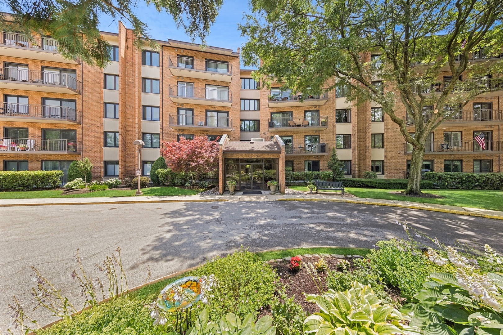 Beautifully maintained and freshly updated FIRST FLOOR, END UNIT with scenic LAKE VIEWS and convenient outdoor access. This 2-bedroom, 2-bath condo offers a comfortable and functional layout with fresh paint and brand new carpeting throughout. The recently redone (2023) kitchen features quartz countertops, a water view, and space for a breakfast table. The living area includes a gas fireplace with brick surround, and large sliders. The primary bedroom includes a full private bath and generous closet space.  Gorgeous plantation shutters throughout. A separate laundry room with utility sink and an assigned garage parking space (#9) add to the practicality of the unit. Located just off the building foyer for easy entry, this condo also includes a new sliding glass door and private balcony to enjoy the outdoors.  Community amenities include walking trails, pickleball and tennis courts, a park, playground, clubhouse and sundeck. The 601 building has an updated party room, and an exercise room overlooking the lake. A new swimming pool is scheduled for completion this summer. A great opportunity for no maintenance living in a desirable, active community with beautiful surroundings and easy access to shopping, dining, and recreation.