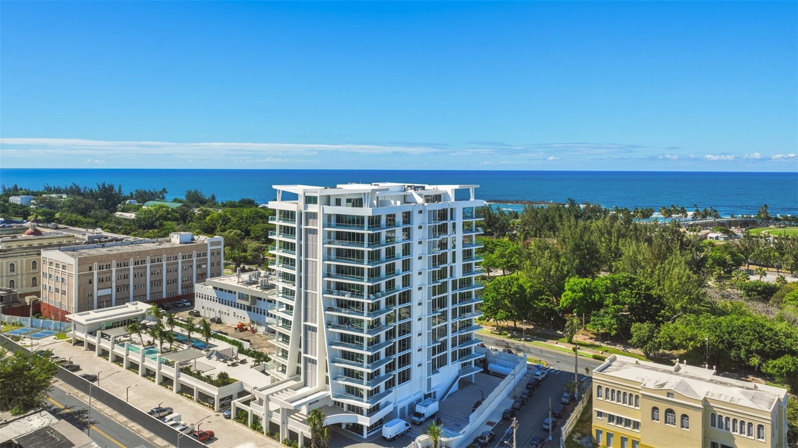 Experience refined urban luxury in San Juan’s most dynamic corridor at Le Parc Condado. Completed in 2025, this rare eighth-floor residence spans 2,740 square feet and showcases a light-filled, open-concept design with floor-to-ceiling glass and soft, modern finishes throughout. An elegant entry foyer leads seamlessly into the living and dining areas, ideal for both everyday living and entertaining. The chef-inspired kitchen features premium finishes and a walk-in pantry, while an expansive covered terrace extends the living space outdoors, capturing cooling sea breezes. Northwest-facing exposures frame sweeping views of the Atlantic Ocean and the historic skyline of Old San Juan. Setting this residence apart are its elevated finishes and thoughtful upgrades throughout, including flush-mounted lighting, electric blinds, an upgraded kitchen hood, and a dedicated electric vehicle charging station. Offered fully furnished in a refined modern style, the interiors reflect a cohesive and timeless design. The home features three spacious bedrooms, each with its own en-suite bath, including a generous primary suite with a walk-in closet. A versatile den, dedicated laundry area, elegant powder room, three assigned parking spaces, and a private storage unit complete the home. As a resident of Le Parc, you will enjoy world-class amenities in an exclusive boutique setting. The building offers 24-hour security and concierge services, multiple pools and Jacuzzis, and a state-of-the-art fitness center complete with a sauna, steam room, cold plunge, and massage room. Outdoor enthusiasts will appreciate the pickleball court and dog park. Additional lifestyle features include a professional business center, dedicated children’s playroom and an expansive rooftop terrace featuring panoramic lounges and private wine cellars. Perfectly situated between the historic charm of Old San Juan and the modern conveniences of Condado, Le Parc offers a lifestyle of unmatched Caribbean elegance.