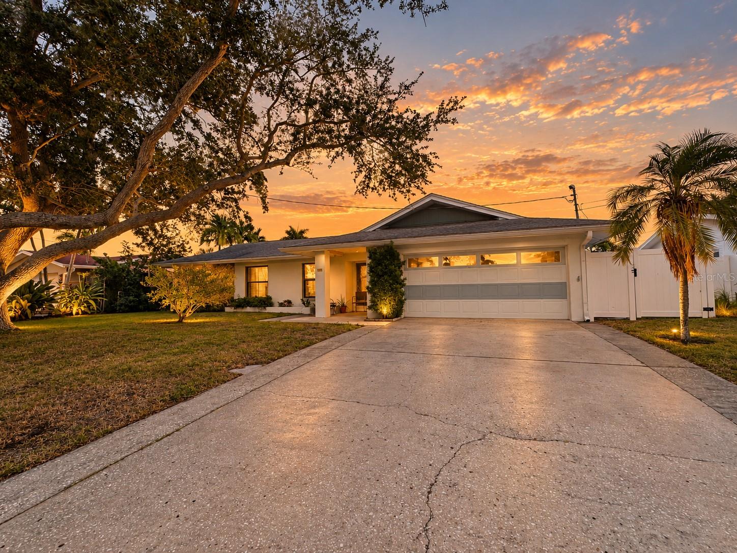 A Rare Opportunity in Patrician Point. Nestled in one of Northeast St. Pete's most sought-after boating communities, this solid block home offers 75 feet of seawall, a private dock with boat lift, and boating access to Tampa Bay without passing beneath any low bridges. Bring the boat! Lovingly maintained by the same family for over 30 years, this residence presents an exceptional opportunity to create something truly special in one of St. Pete's most desirable neighborhoods. Step inside and you'll discover a bright, open layout featuring porcelain tile flooring with original terrazzo preserved underneath, offering the opportunity to restore a timeless piece of the home's mid-century character. The thoughtfully designed split floor plan features a spacious primary suite with walk-in closets and an ensuite bath, along with a separate guest suite complete with its own private bathroom, ideal for extended family or overnight guests. At the heart of the home, a generous family room anchored by a wood-burning fireplace creates an inviting space to gather and entertain. Just beyond, step outside onto the expansive deck, where peaceful canal views and gentle coastal breezes provide the perfect backdrop for morning coffee, afternoon cocktails, or evenings spent with friends and family. Mature landscaping and established trees add privacy and natural beauty to the setting. And then there's the location. You're just minutes from vibrant Downtown St. Petersburg, waterfront parks, shopping, dining, and everything that makes Northeast St. Pete such a sought-after place to call home. Whether you're envisioning a modern coastal transformation or simply a place to enjoy the boating lifestyle while making it your own, this property presents an exceptional opportunity. The location, the lifestyle, and the possibilities are already here. All that's missing is you.