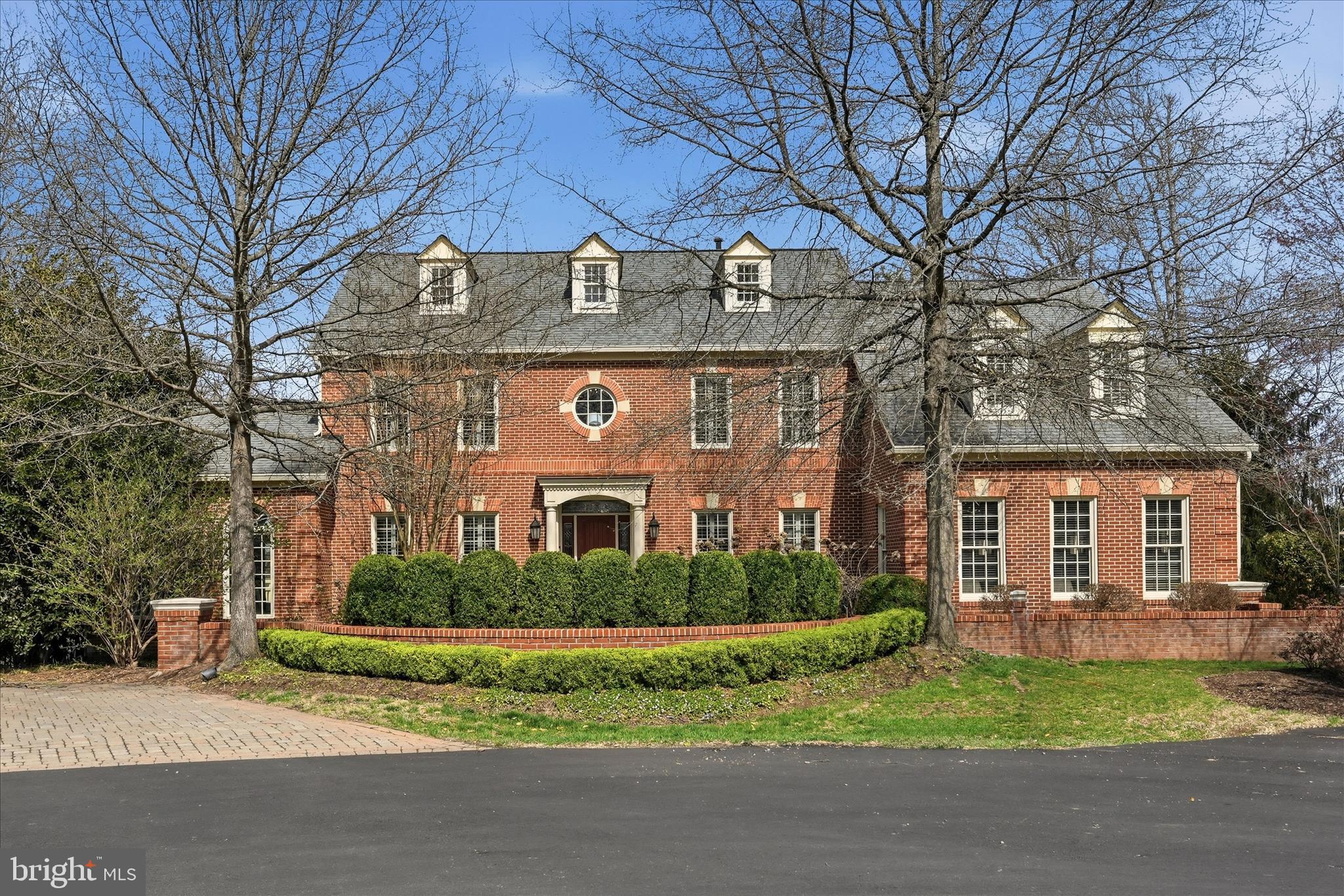 A discreet, estate-style colonial in Langley School District, features a private in-ground pool, set on .83 acres at the end of a quiet cul-de-sac in one of Reston's most established enclaves…ideal for buyers seeking privacy, quality, and proximity without compromise. Tucked away in the Brandermill community, this four-level brick colonial pairs resort-style outdoor living with timeless architecture and thoughtful interior updates. Designed to accommodate both grand-scale entertaining and everyday living, the residence features six bedrooms and five-and-a-half baths, including a finished attic-level suite with bedroom and full bath…ideal for guests, extended family, or a private executive retreat. The interior has been refreshed with transitional finishes and fresh, neutral paint, anchored by a light-filled two-story family room. Multiple living spaces, including a sunroom and sitting room, provide flexibility and effortless flow for formal gatherings and more intimate moments alike. At the heart of the home, the gourmet kitchen is equipped with Viking appliances, granite countertops, and a layout that connects seamlessly to the surrounding living areas, well-suited for daily living as well as catered entertaining. Recent improvements include newly installed LVT flooring in the secondary bedroom ensuite, hall bath, and lower-level gym, offering durability and a clean, modern aesthetic in high-use spaces. Outdoor living is a defining highlight. Extensive multi-level decking on three sides of the home overlooks the in-ground swimming pool, framed by mature landscaping and scenic views…creating a private, resort-like environment rarely found close-in.