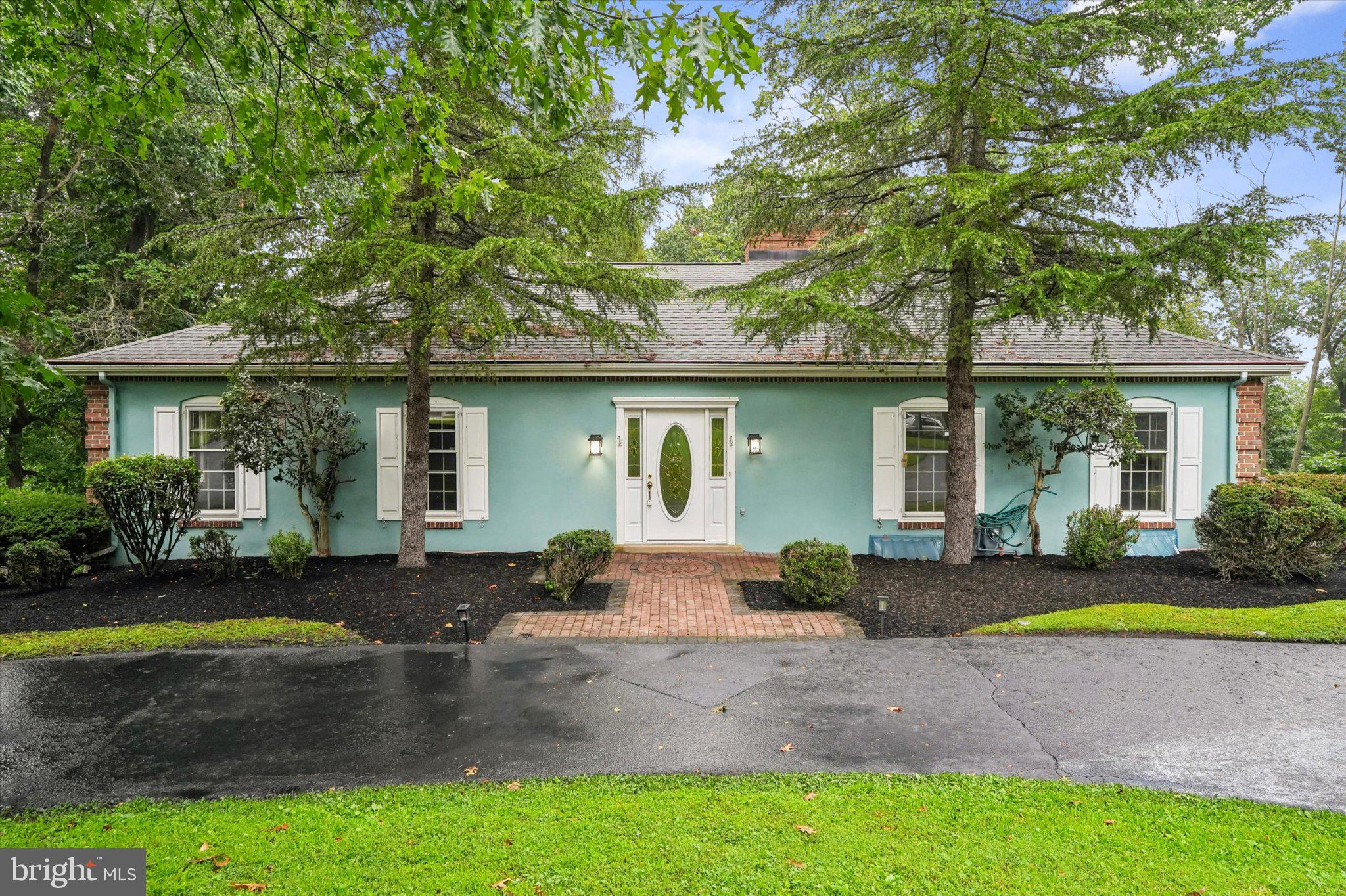 Welcome to 171 Gulph Hills Road, a private 3-bedroom, 3-bath home set on 1.25 wooded acres in Radnor. Step into the foyer and immediately take in the expansive living room straight ahead, where dramatic picture windows fill the space with natural light and frame beautiful views of the surrounding trees and greenery. Hardwood floors throughout add warmth and character, while an adjoining dining area, fireplace, and access to the deck make this an inviting space for both everyday living and entertaining. Just off the foyer to the right, the eat-in kitchen offers a second fireplace and plenty of room to gather. The main level also offers convenient first-floor living, including a spacious primary suite with a private bath and direct access to the deck.The walk-out lower level features a spacious great room with a third fireplace and its own large picture windows, bringing in abundant natural light and continuing the home’s connection to the wooded setting. A working dumbwaiter adds a unique and functional touch, while the large attic provides excellent storage and future possibilities.Outside, enjoy the peaceful setting from the deck, along with a paver patio area, a charming gazebo and a picturesque Koi pond. An attached garage offers plenty of storage space, and there is a separate heated and air-conditioned hobby room.Conveniently located near shopping, dining, major roadways, and all that Radnor, the Main Line, and King of Prussia have to offer, this home blends privacy, character, and versatile living space in an exceptional location.
