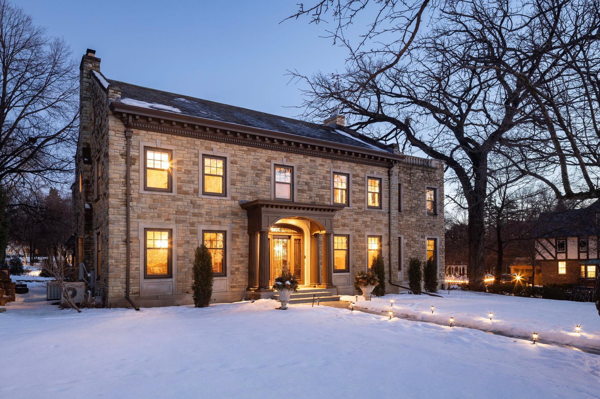 One of the finest homes in Minneapolis, virtually irreplaceable with custom finishes throughout and stunning views over Lake Harriet.  Custom onyx, marble, terrazzo, tile & hardwood flooring throughout all 4 floors. High ceilinged, complemented by wainscoting, beamed ceilings and generous windows.  Grand reception hall/foyer anchored by marble staircase with wrought iron balustrade.  The formal living room with gas fireplace has a beamed ceiling and mosaic marble floors; it leads to the sunroom with gas fireplace & hardwood floors, with access to the rear yard.  A columned dining room offers marble floors, natural woodwork & deep windows, while the center island kitchen with hardwood floors leads to a step down breakfast room with custom tile flooring.  A pantry, ½ bath, mudroom & laundry complete the main level.  The current owners added the handsome barrel-vaulted mezzanine level library/family room and bedroom suite, sunroom, pantry & laundry on main, and primary suite upper level to the home 18 years ago, which blend seamlessly with the interior and exterior of the home. The library is surely one of the most magnificent rooms in any south Minneapolis home; extensive cabinetry there is complemented by a gas fplc, wainscoting and hardwood floors.  On this level are also located a marble floored office with onyx topped built-in desk and airy bedroom with ¾ bath.  A full flight up, the grand terrazzo floored central hall includes the lake facing marble floored sitting room, 2nd bedroom with private ¾ bath, and the sumptuous primary suite, whose steel reinforced double entry doors open onto a foyer rotunda, leading to the luxurious full private bath with dual vanities, steam shower, whirlpool & bidet, spacious walk-in closet with a hidden safe, and generous bedroom with gas fplc, lake views & TV hidden behind a painting. A 2nd laundry is also located on this level, as well as a large auxiliary clothes closet.  On the 3rd floor is a ballroom/playroom with hardwood floors, 4th bedroom & full bath with custom tilework.  A wide marble staircase leads to the lower level with mosaic tiled foyer, full bath with whirlpool & 2nd steam shower, as well as marble floored amusement room with gas fplc & custom plaster reliefs on the walls. An auxiliary kitchen & wine storage are also located on this level.   Additional amenities include 3+ car attached garage, fenced yard, central air, hydronic radiant heat throughout for low energy costs, generator, security system & marble radiator covers.  A once-in-a-lifetime opportunity, solidly built and lovingly cared for.