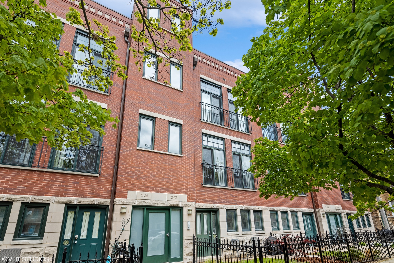 Spacious 2BR/2BA duplex condo in North Center on a beautiful tree lined street in the Coonley School District! This home lives like a townhome with nice open floor plan. Living room with Juliette balcony and cozy gas fireplace flows into dining area. Kitchen with stainless steel appliances, granite counters, 42" maple cabinetry. Hardwood floors throughout living areas! Master Suite features large walk-in closet and dual vanity in bathroom. Split floor plan is perfect for guests. Side by side washer/dryer. Enjoy your patio in the front of house along with a common roof top deck. Incredible city views! Massive 20'x19' attached (2) car garage has plenty of room for additional storage. A+ location! Walk to Coonley School, Welles Park, Starbucks, Jewel, Trader Joe's, Brown Line CTA & Metra station, Shopping, dining, and entertainment all around you. Quick ride to the lake! Located in the vibrant North Center neighborhood-often referred to locally as Lincoln Commons-2038 W. Warner Ave sits on a leafy, residential stretch offering a charming mix of urban convenience and community amenities.