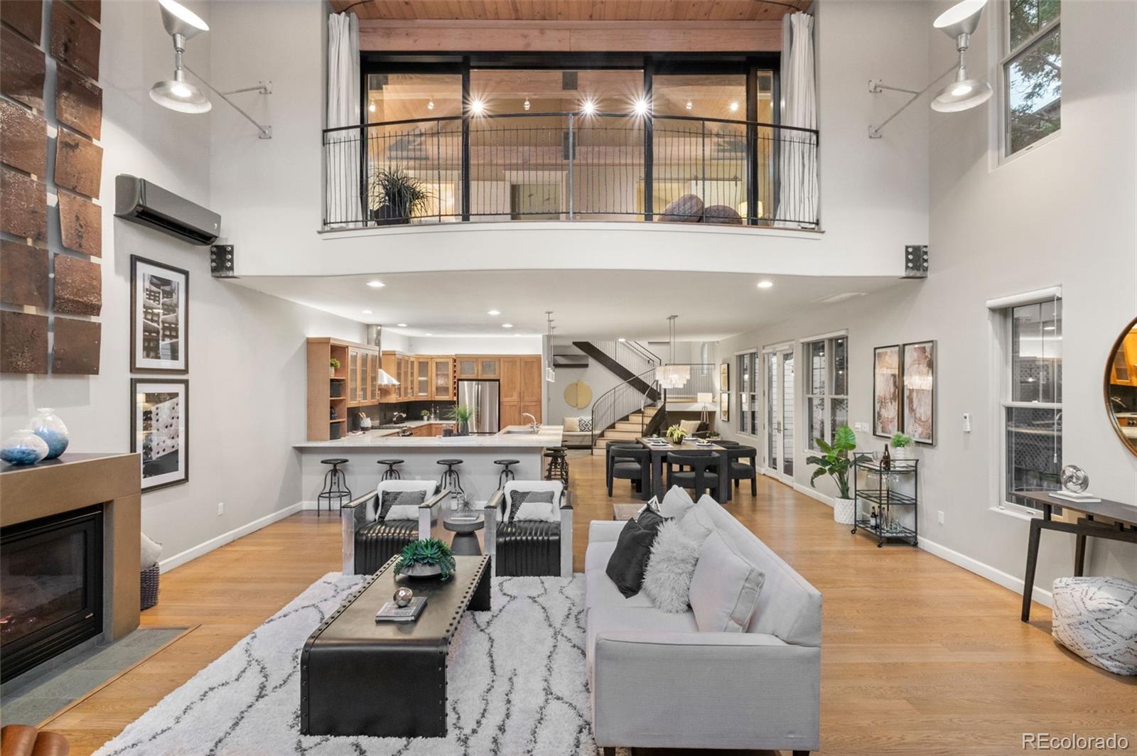 One of a kind stunner!  The attached 3 car garage is climate controlled and has 20' ceilings with ample storage and the ability to install a car lift for even more parking.  Behind a custom metal gate and framed by lush landscaping on a rare double lot in the heart of LoHi, this beautiful home appears unassuming. Once you step through the front archway, though, into a light-filled interior where 25-foot vaulted ceilings and a flowing, open floor plan you'll be amazed. Designed for modern living and entertaining, the main level seamlessly connects the living room, dining area, and kitchen—anchored by rich wood floors, clerestory windows, and a gas fireplace. The kitchen blends style and function with marble countertops, custom wood cabinetry, a walk-in pantry, built in wine rack and bar seating for 8.  French doors in the dining room open to a spacious covered patio perfect for relaxing or hosting. Upstairs, the loft-style primary suite with a full gable glass folding wall offers a private retreat with a 5-piece bath and generous walk-in closet. Two additional bedrooms, a full bath, laundry room and a balcony complete the upper level.The finished basement adds even more flexibility, with 8-foot ceilings, a large bedroom, full bath, and extra storage space. The basement could be reimagined into a mother in law suite for multi generation living or additional income.  Stylish, functional, and full of personality, this one-of-a-kind LoHi home is made to impress.  Lohi is one of Denver's most walkable neighborhoods, and features landmarks like the La Raza park, Little Man Ice Cream Co., Linger, Avanti, Happy Camper Pizza, Root Down, Highland Tavern, Prost Brewing and so many more!  You won't find anything like it in Denver or a better location.  Video walk through here: https://youtube.com/shorts/4eN84FMoHHM?feature=share   Welcome home!